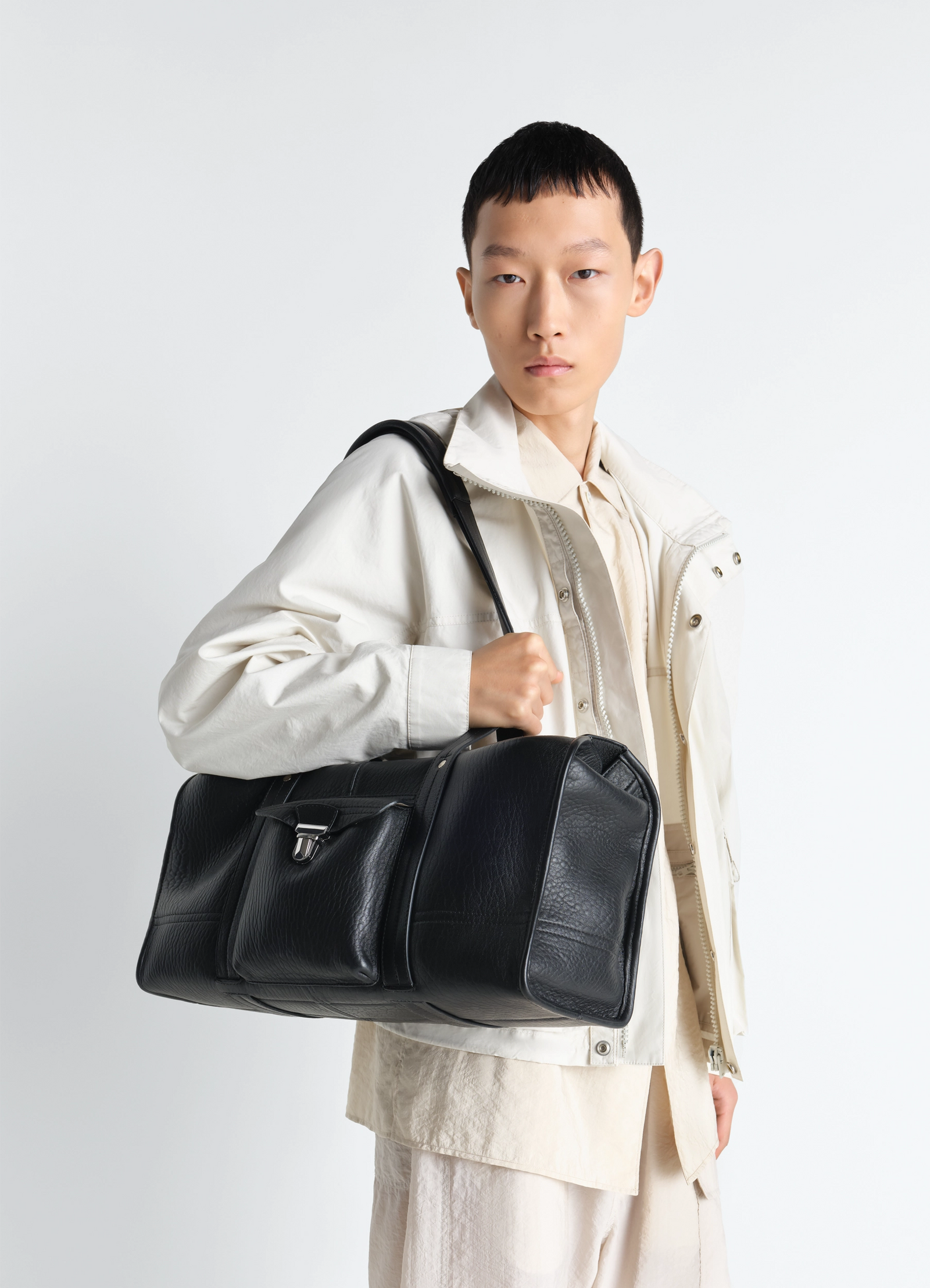 Lemaire soft gear tote bag in black bubble leather, model shot, side view textured leather