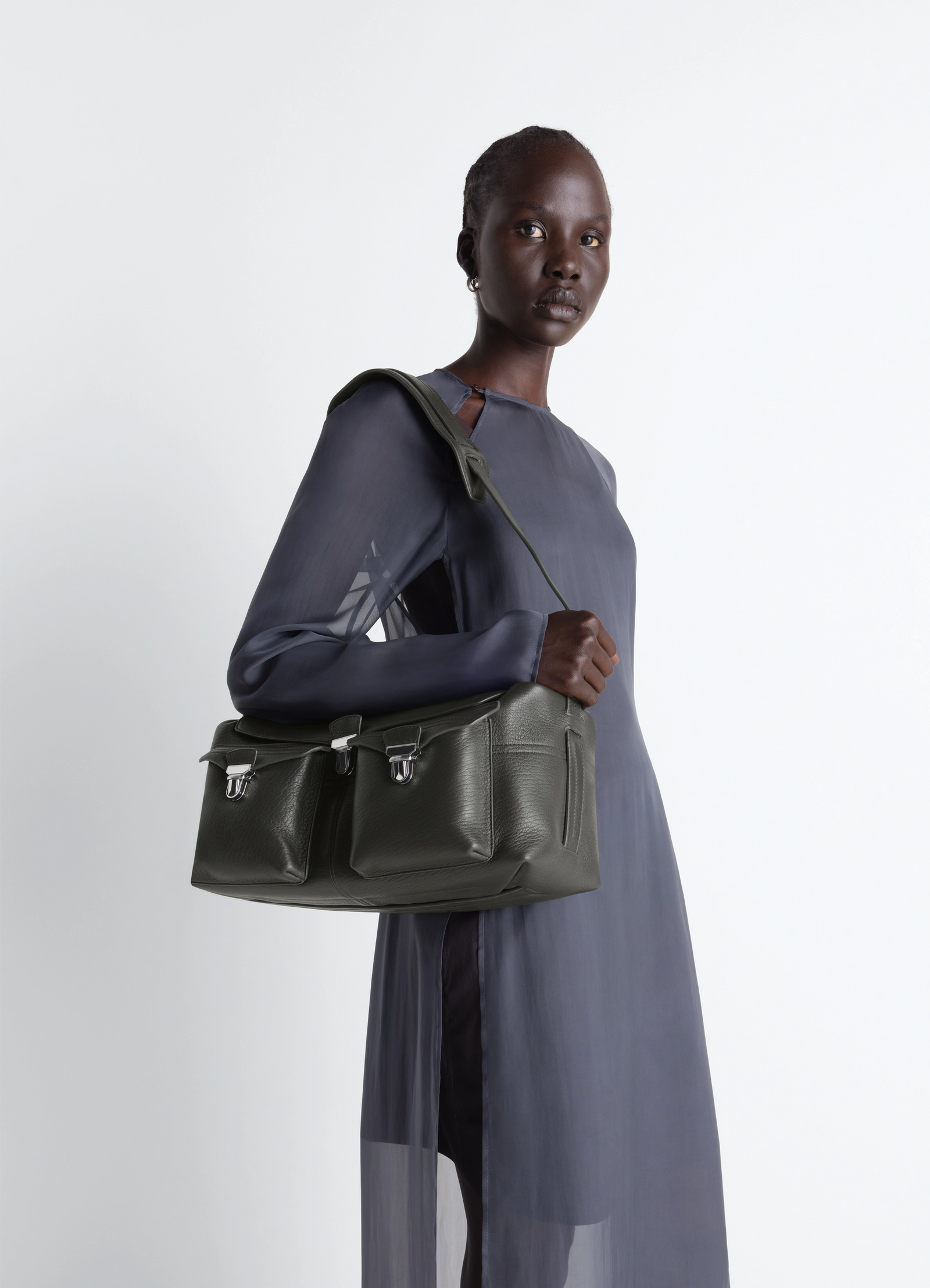 Lemaire soft gear bag in bubble lamb leather, model shot, side view worn on shoulder