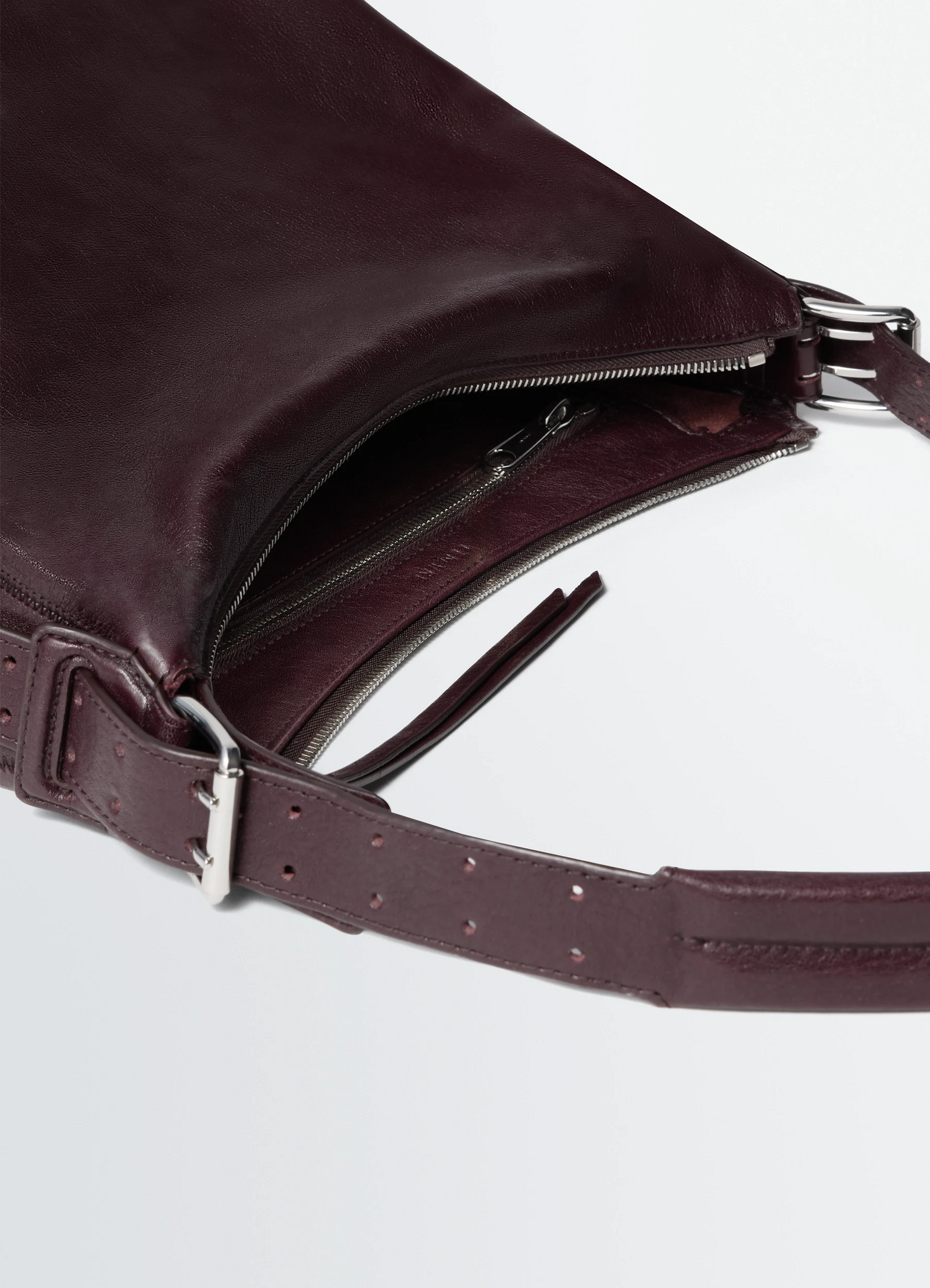 Small belted hobo bag in paper lux leather, product shot, top detail view zipper closure, belt accents
