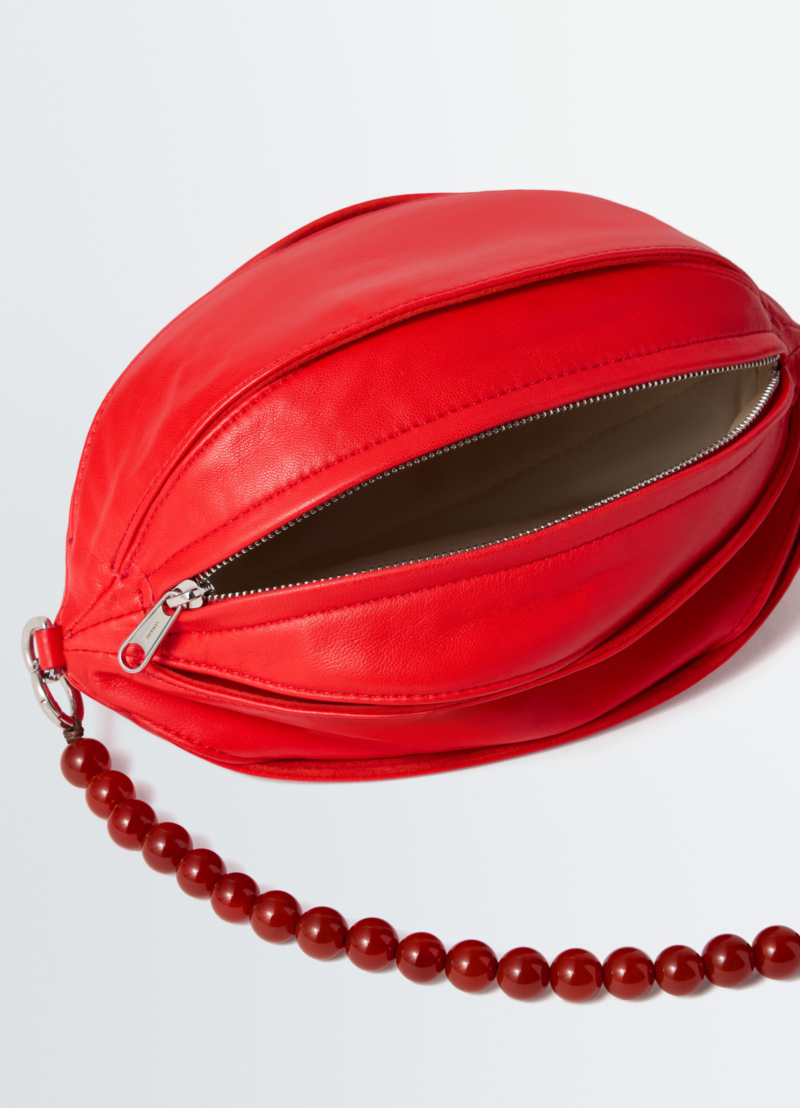 Balloon slits bi-material bag in red nappa lamb leather, product shot, top view open zipper detail