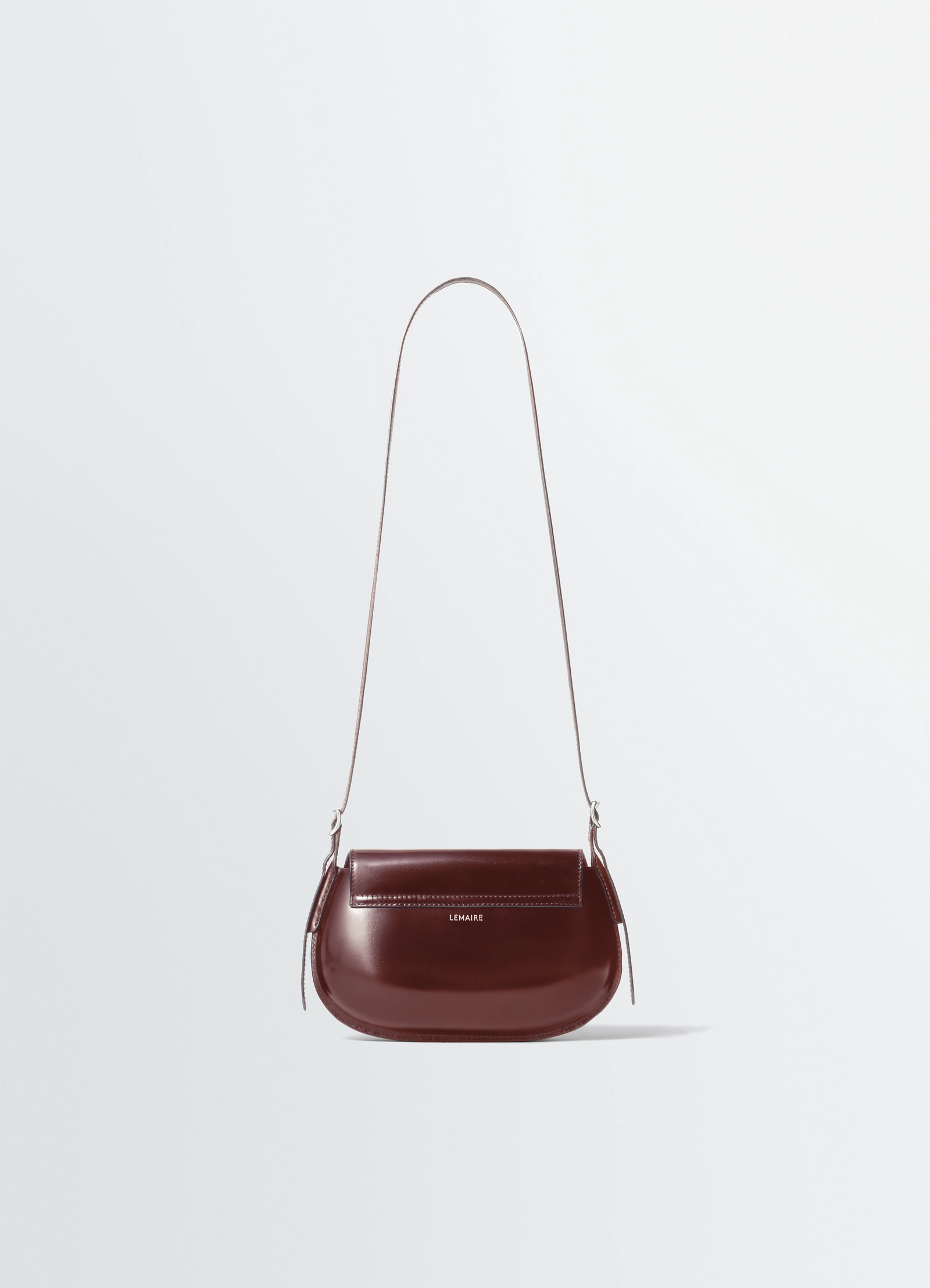 Lemaire belly bag in patinated silver leather, product shot, back view sleek shiny surface