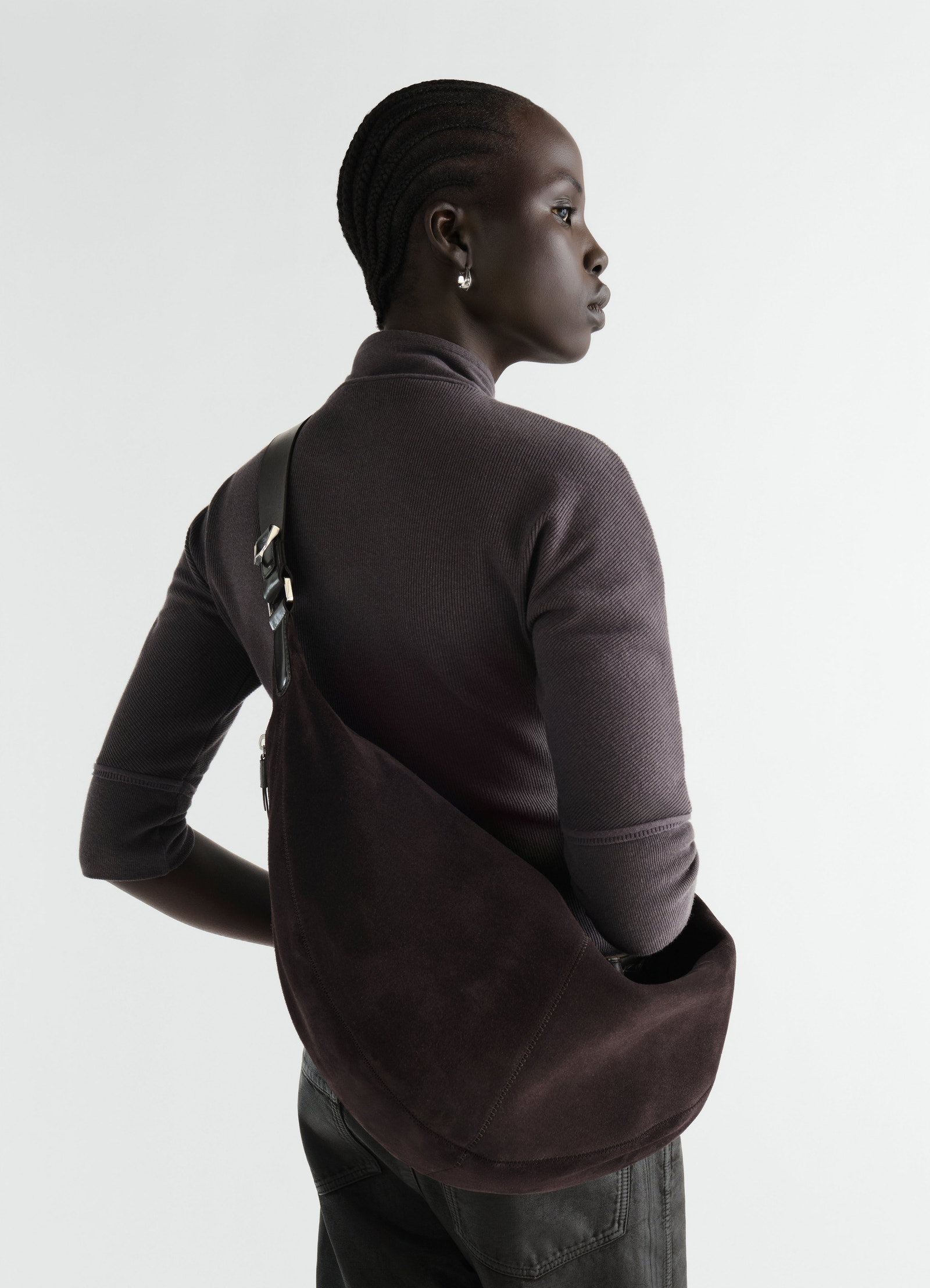 Quiver clip suede leather bag in dark brown by lemaire worn by model side view