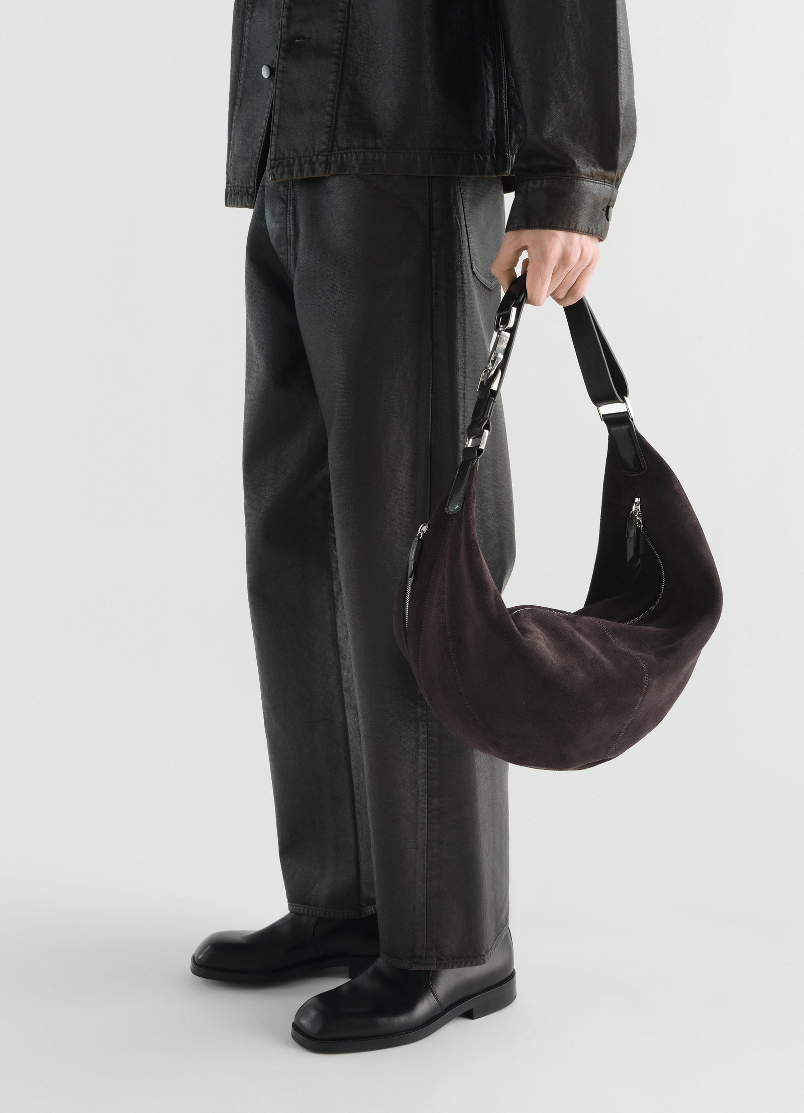 Quiver clip bag in dark brown suede leather lemaire worn by model side view with black outfit and boots