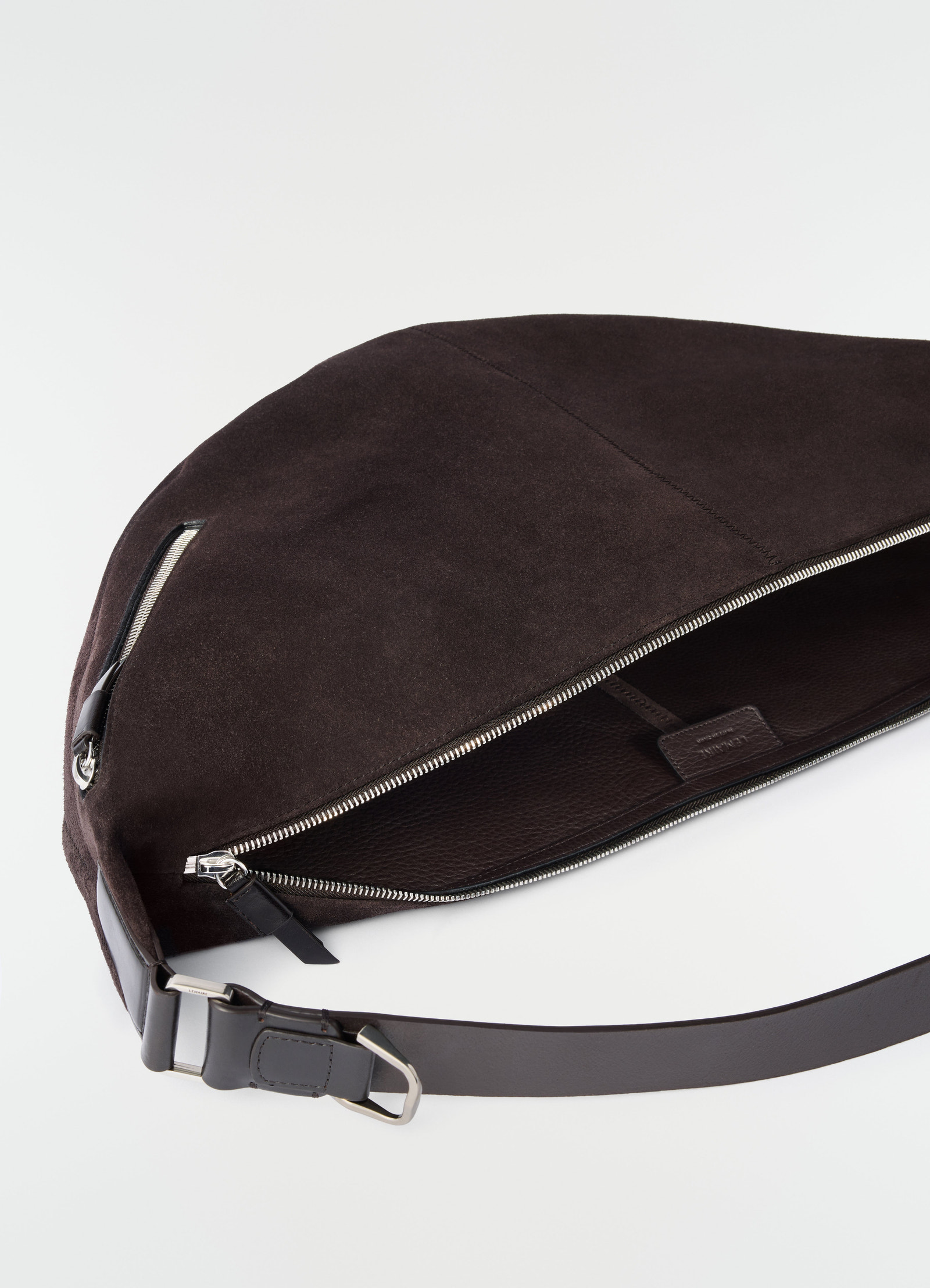 Quiver clip suede leather bag in dark brown with silver zipper detail by lemaire on white background close-up