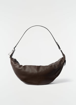 Quiver clip bag lemaire in dark brown leather with silver hardware on plain white background front view
