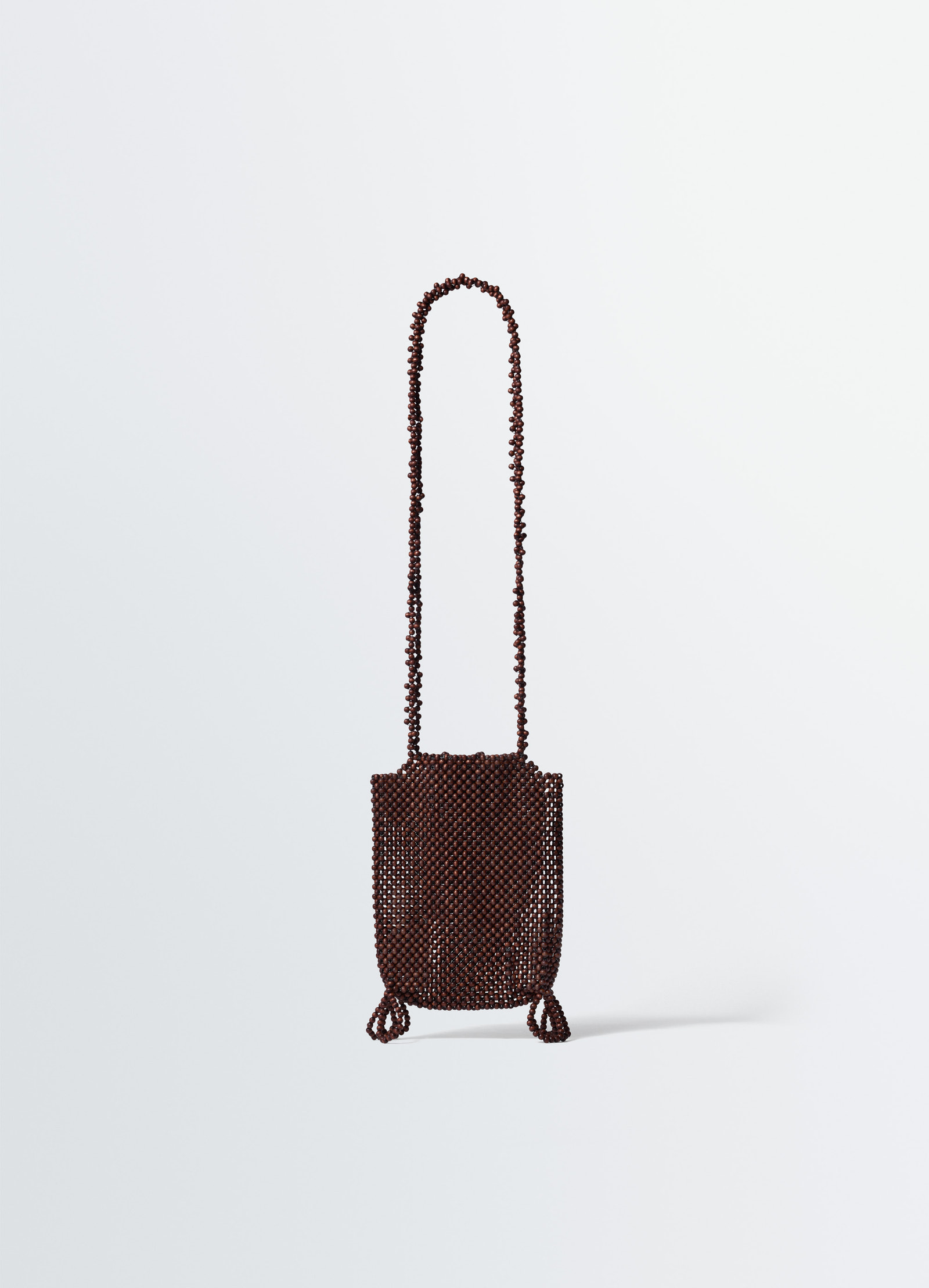 Lemaire grigri phone holder in wooden beads, product shot, back view textured surface