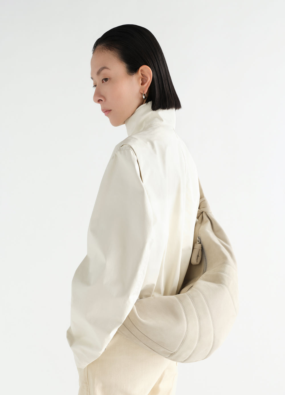 Large beige Croissant bag in alpaca nubuck by LEMAIRE worn by model side view