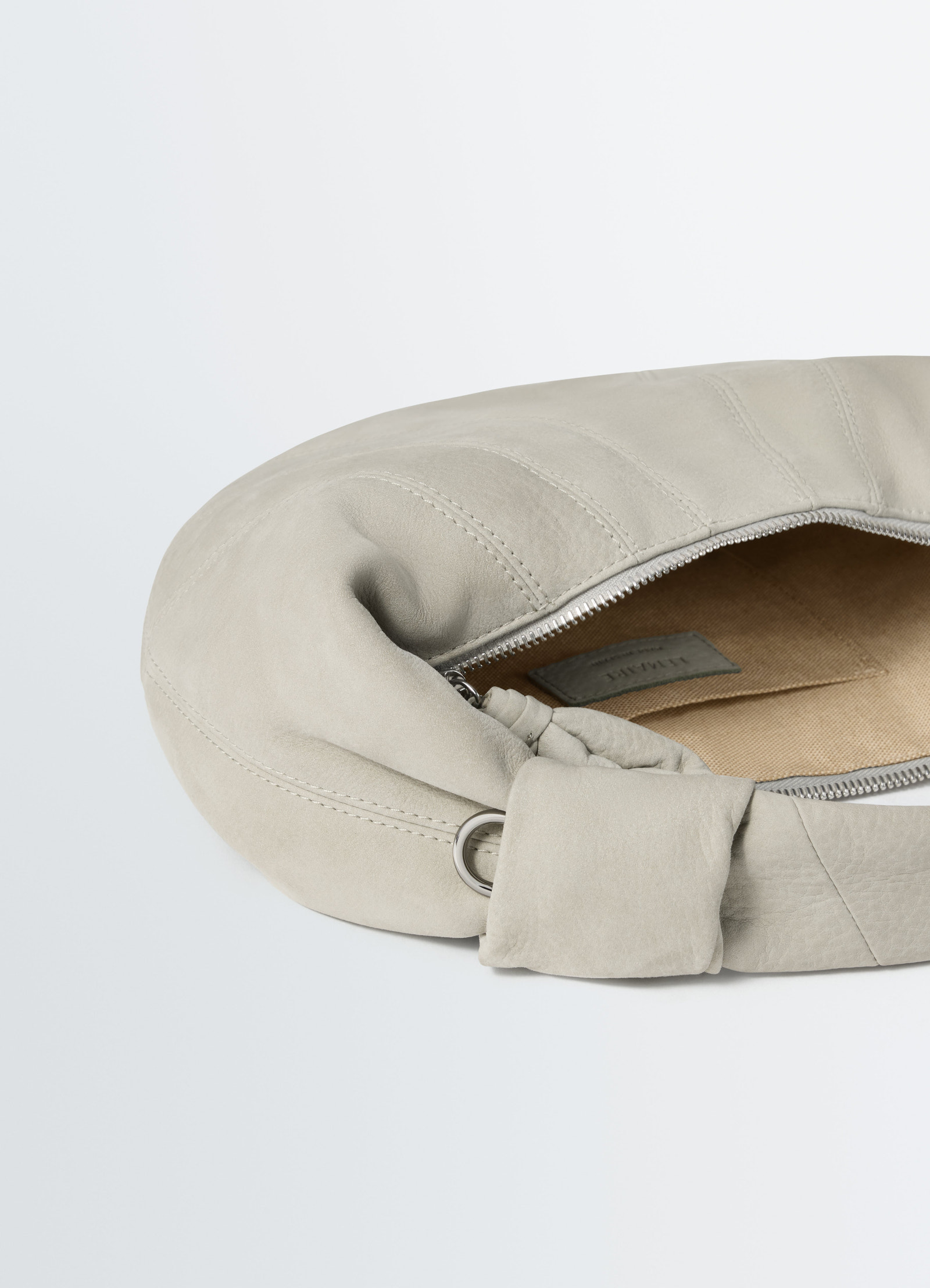 Mini fortune croissant bag in beige alpaca nubuck leather by lemaire close-up front with zipper open on white background