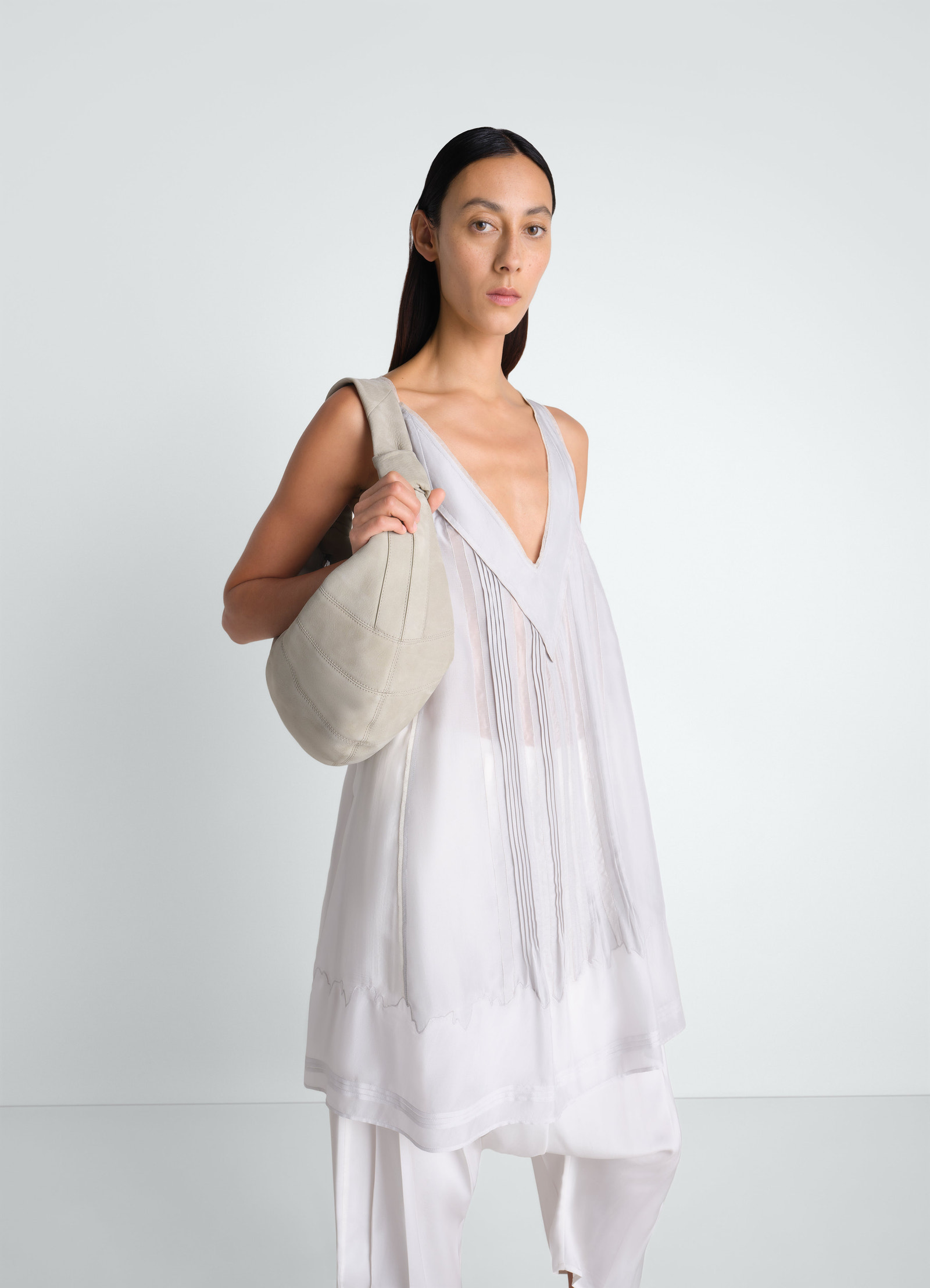 Fortune croissant bag in beige alpaca nubuck worn by model front view lemaire