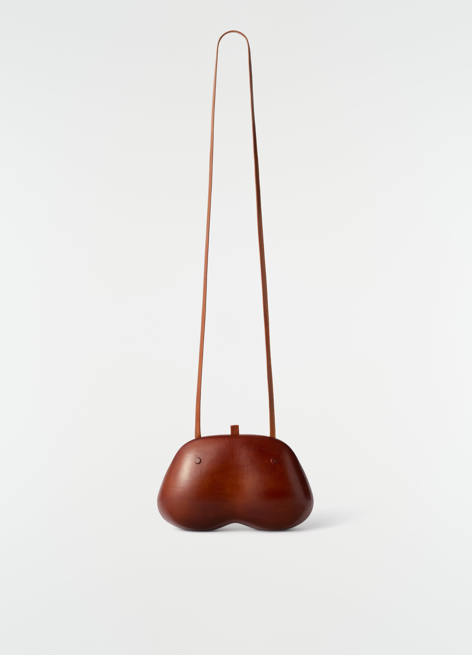 Fesses clutch in brown patinated calfskin with long strap by lemaire front view on white background
