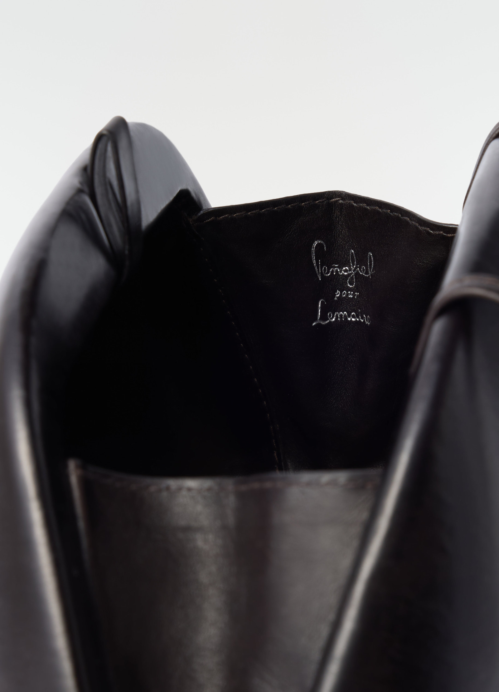 Fesses black patinated calfskin leather clutch by lemaire close-up detail inside logo stitching