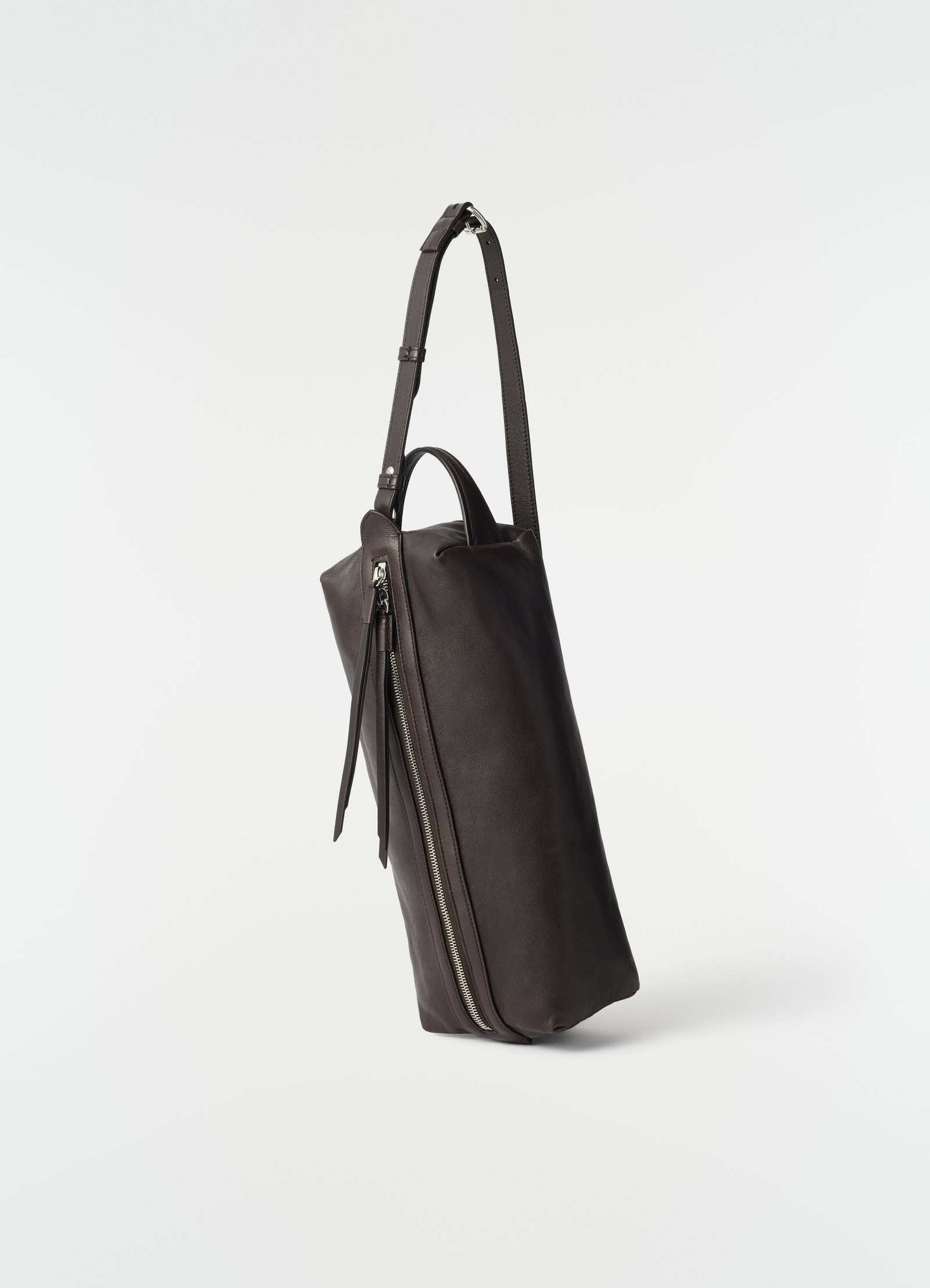 Care shoulder bag in dark brown nappa lambskin with silver zip detail by lemaire side view on white background