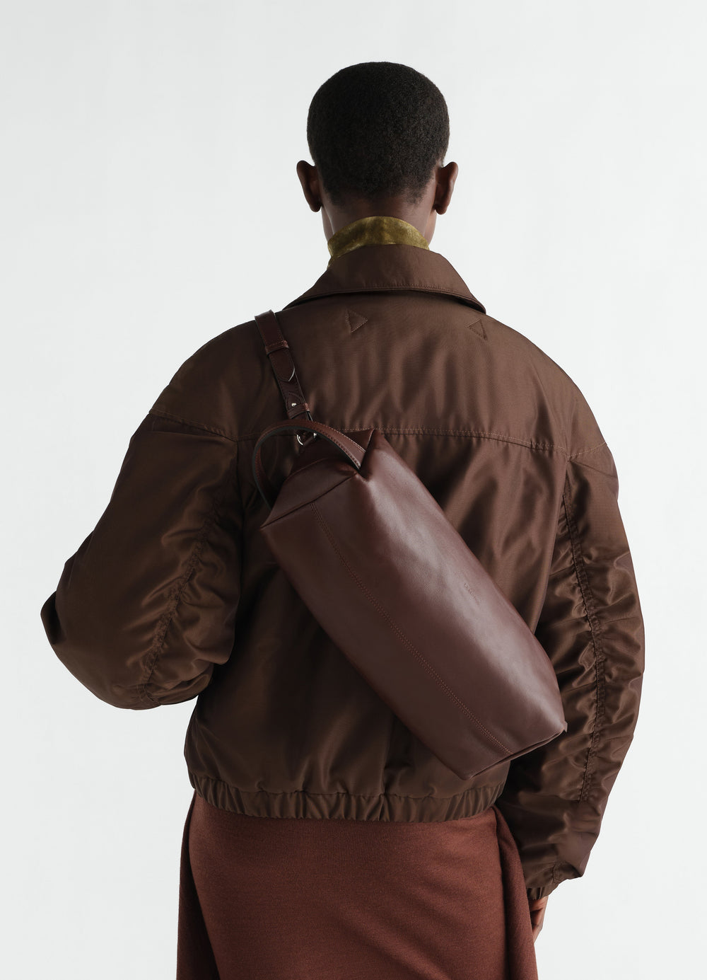 Sac à bandoulière care en cuir d'agneau nappa, coloris marron, porté par un mannequin, vue de dos