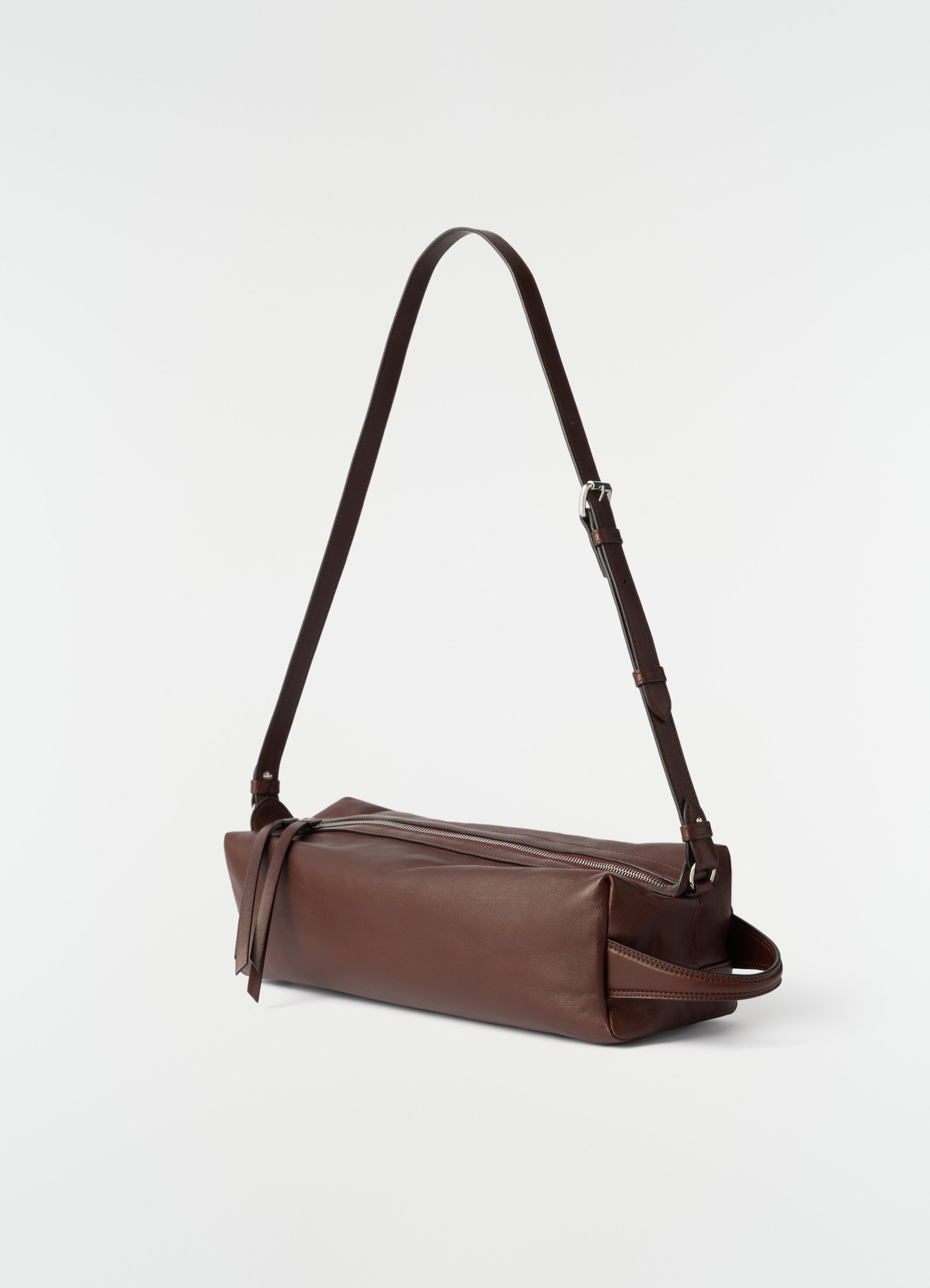 Care shoulder bag in brown nappa lambskin with adjustable strap lemaire side view on white background