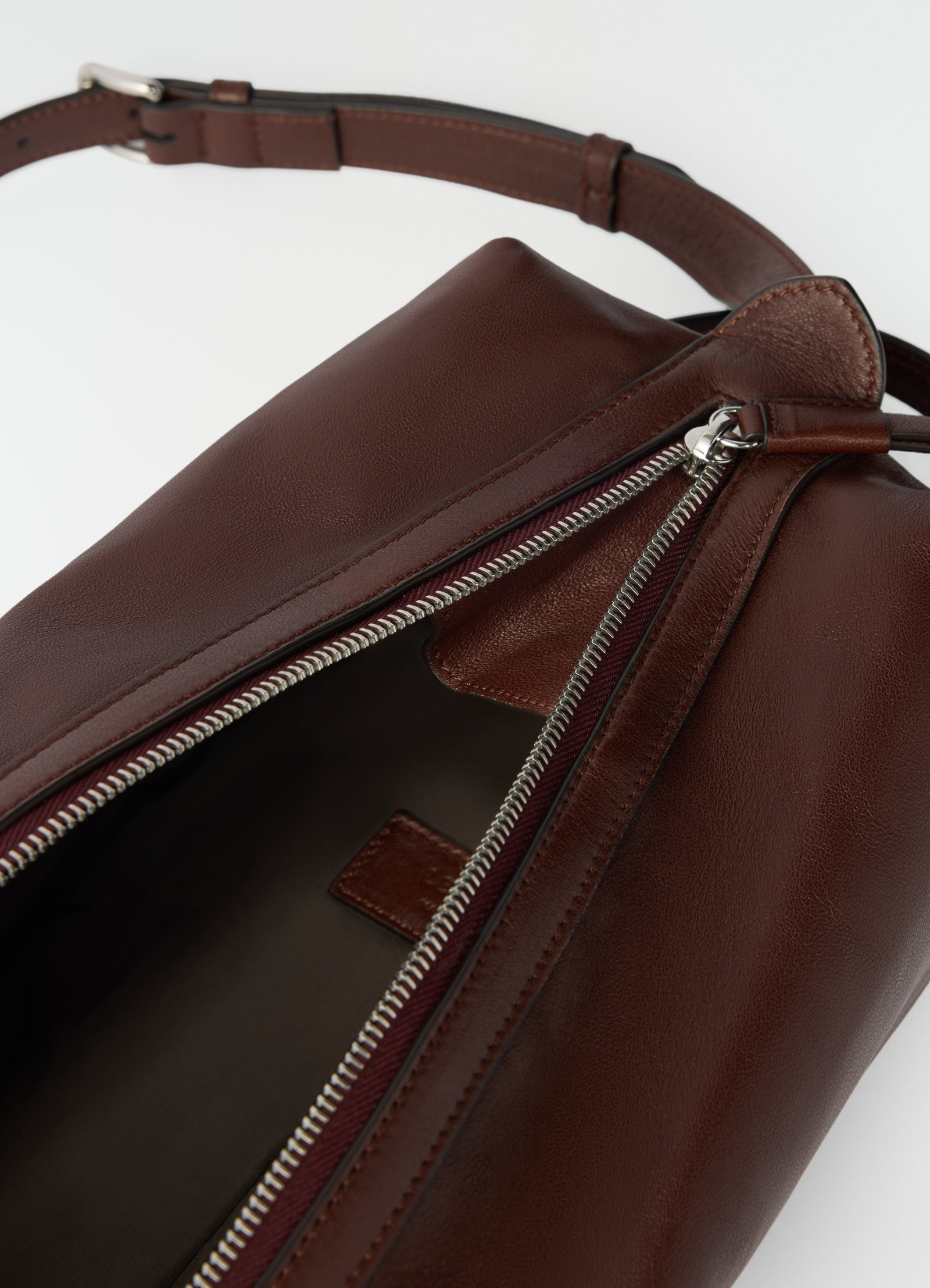 Care shoulder bag in brown nappa lambskin with silver zipper detail by lemaire close-up front view