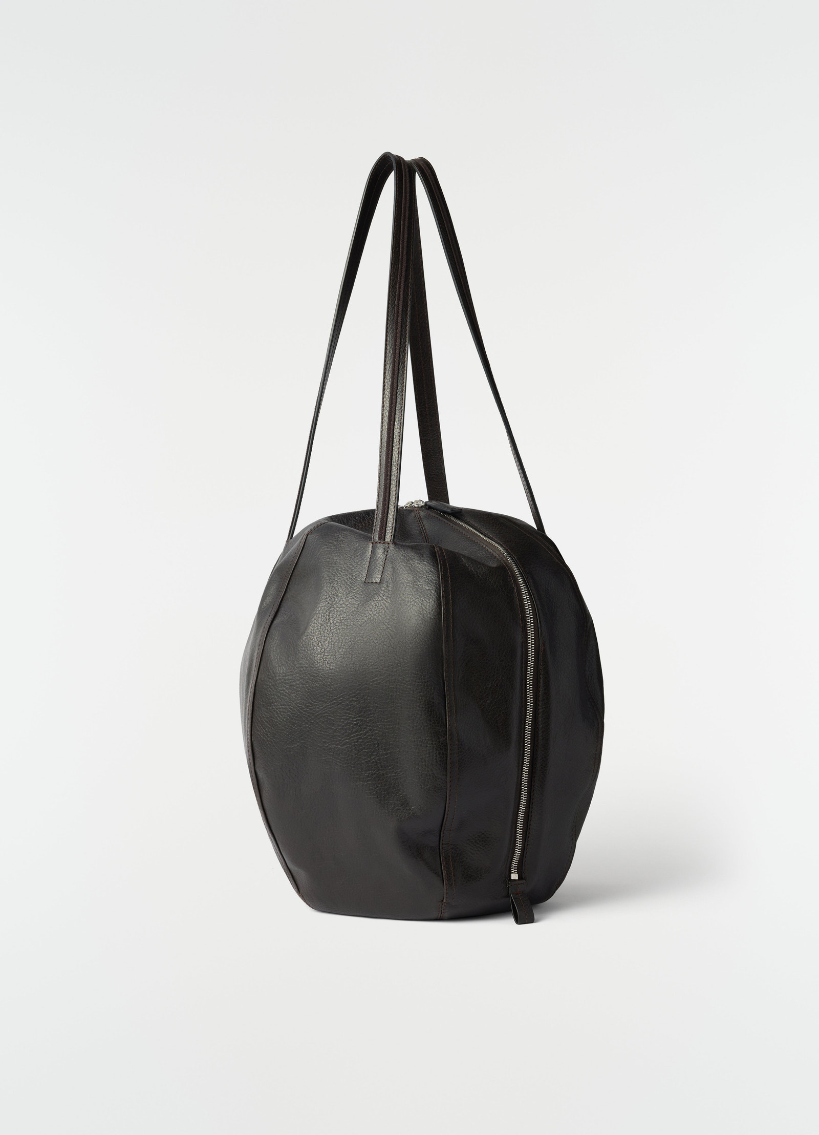 Hobo helmet bag in black grained paper leather lemaire side view with zipper and long handles on white background