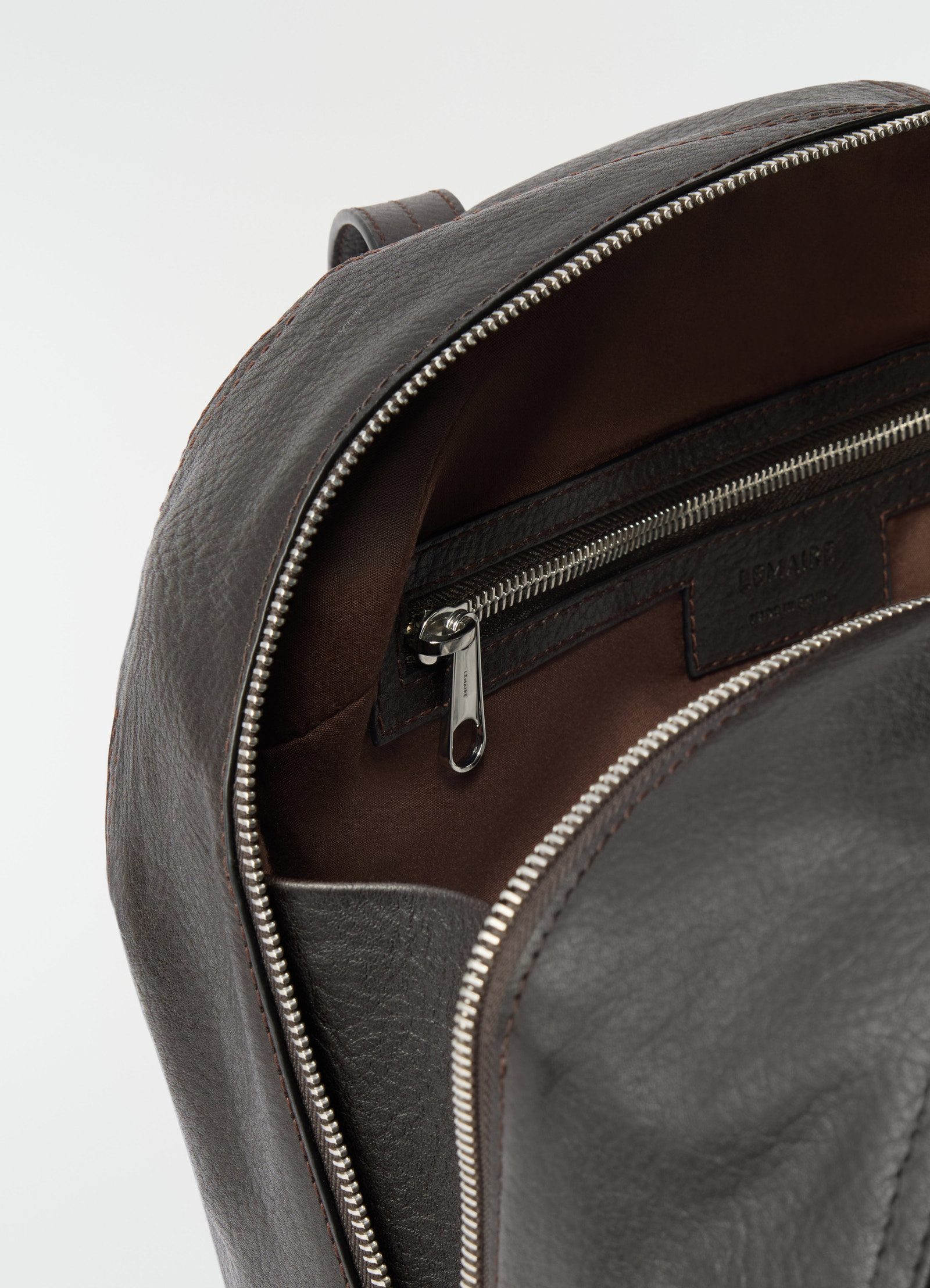 Hobo helmet bag in dark brown grained paper leather by lemaire close-up of interior zipper pocket detail