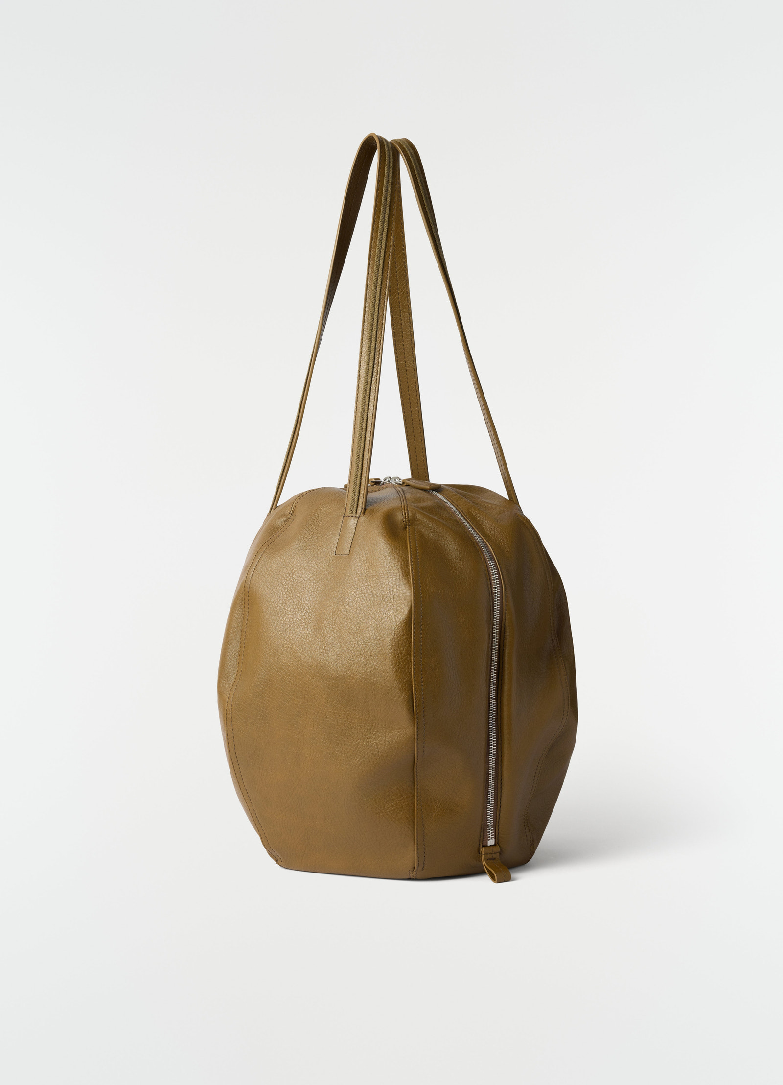 Hobo helmet bag in brown grained leather with side zipper by lemaire on plain white background
