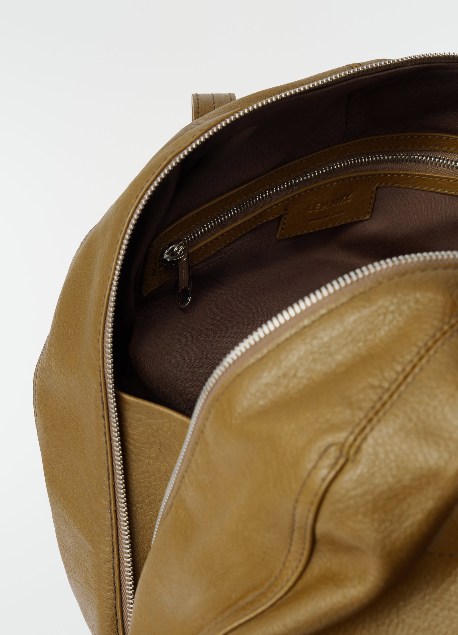 Hobo helmet bag in grained paper leather camel brown by lemaire open view of interior pocket with zipper