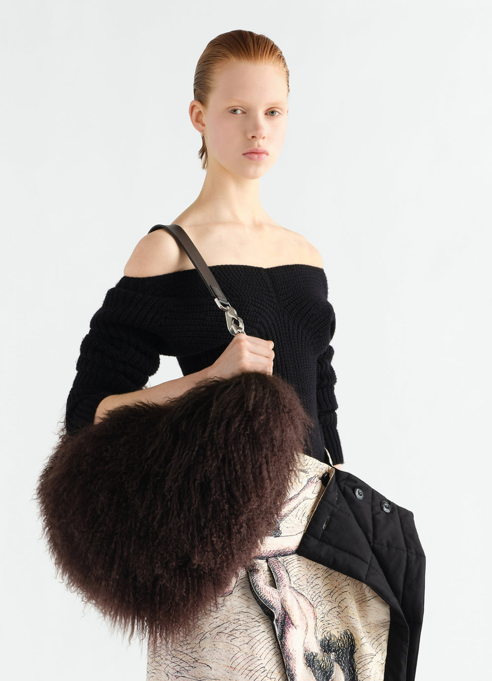 Quiver Clip Bag in dark brown Mongolian lambskin worn by model with black off-shoulder knit, LEMAIRE