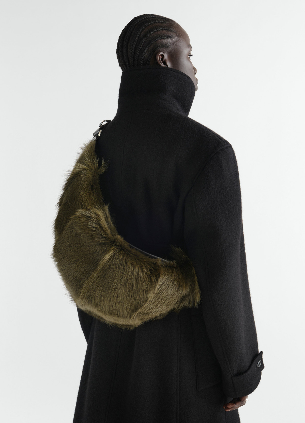 Quiver clip bag in olive long-hair goat leather worn crossbody with black wool coat lemaire back view