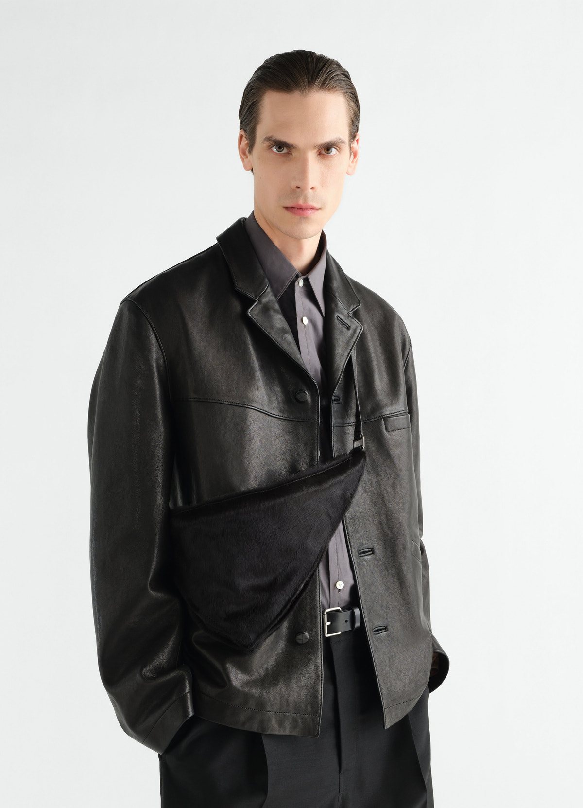 Pocket scarf bag in black pony-style leather worn by a model front view lemaire