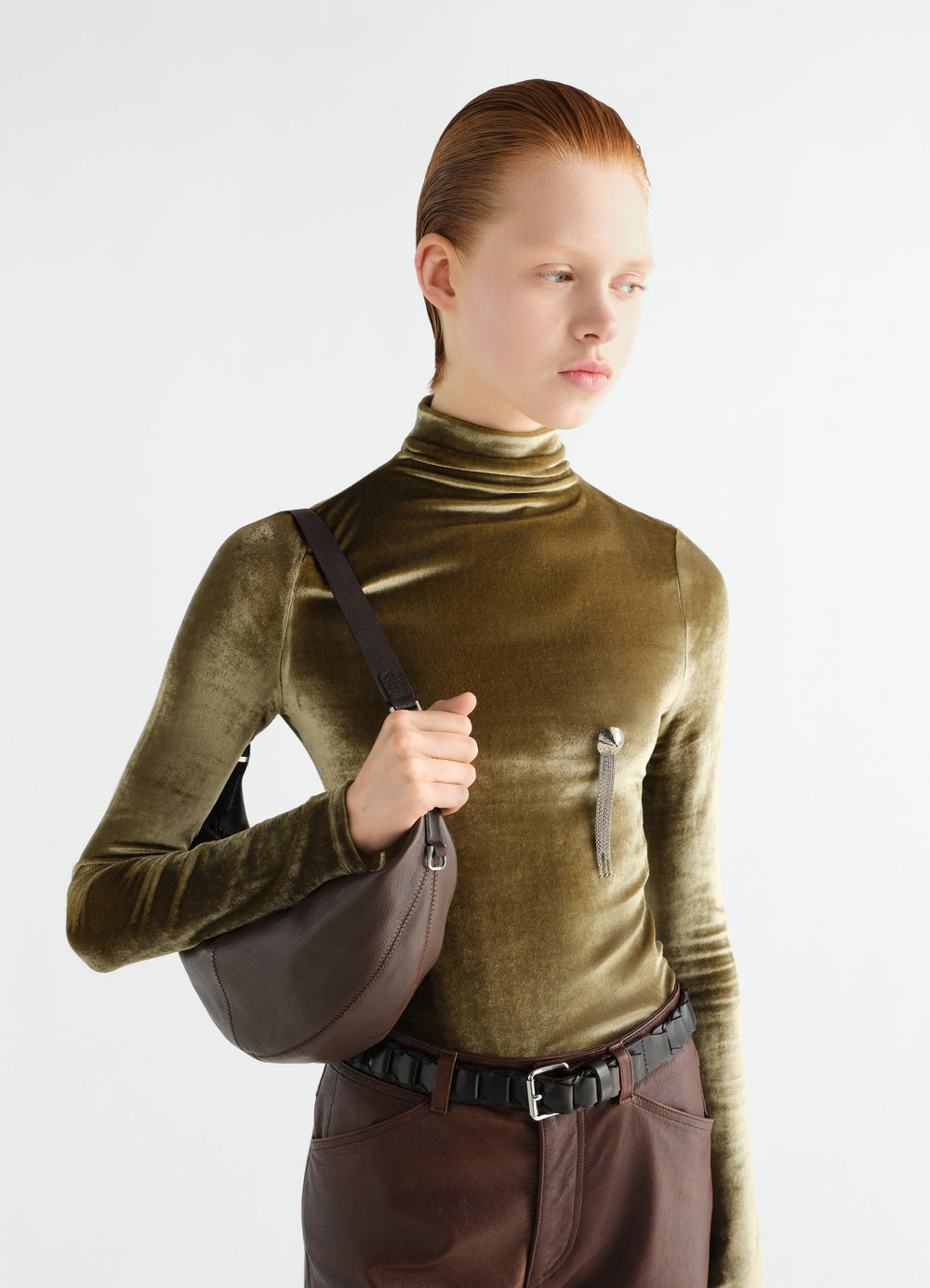 Mini Quiver Clip Bag in dark brown grained buffalo leather worn by model with olive velvet top LEMAIRE