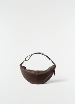 Mini quiver clip bag in brown grained buffalo leather by lemaire on plain white background front view