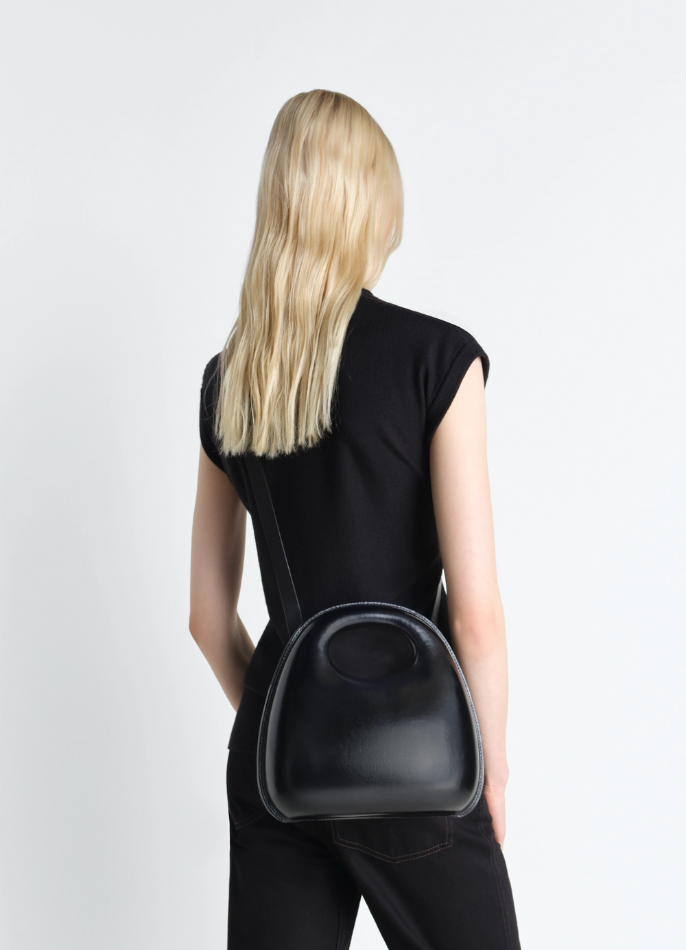EGG BAG IN MOLDED LEATHER in patinated molded leather, model shot, back view worn over shoulder