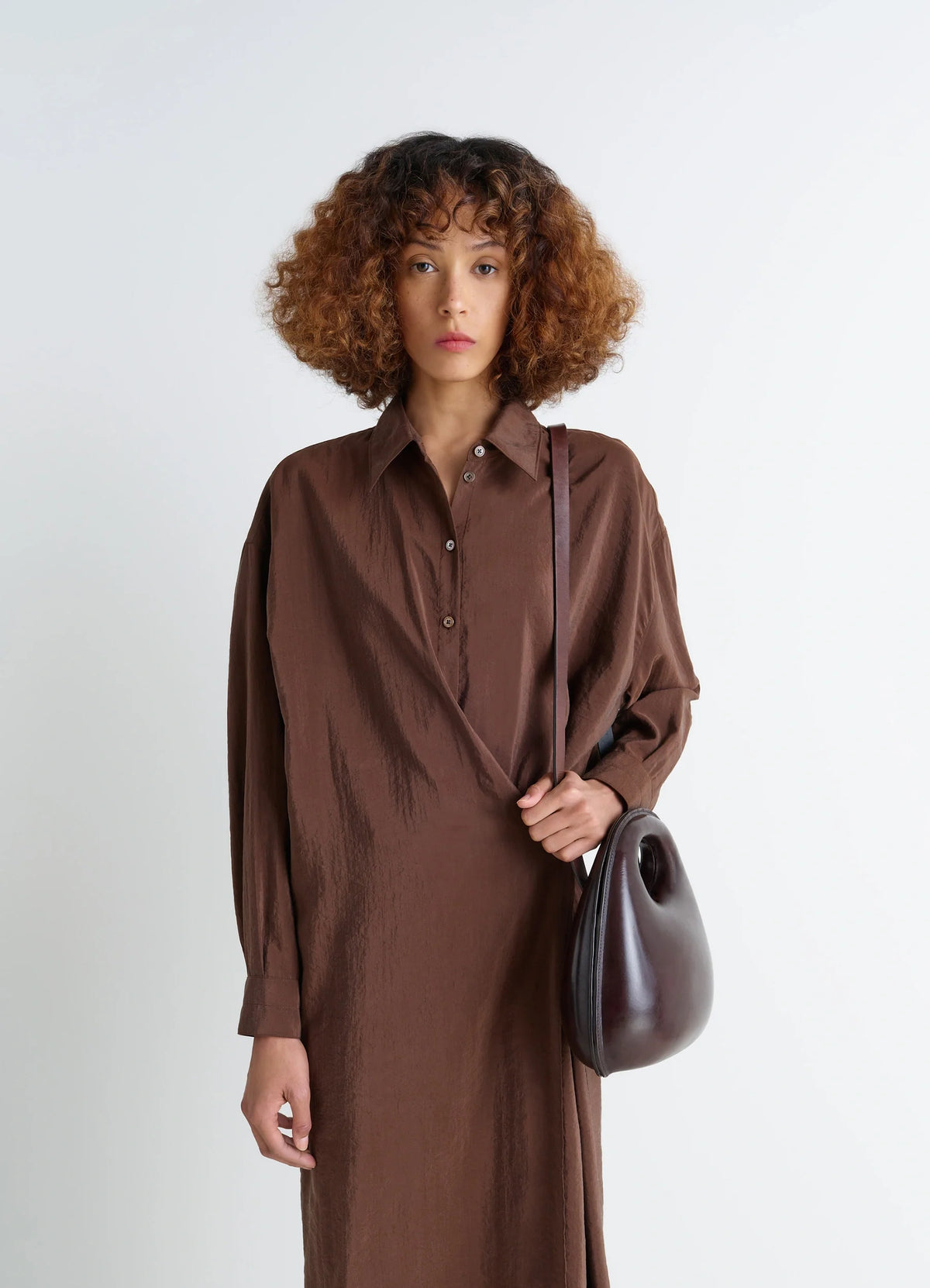 Lemaire Egg Bag in Patinated Leather Brown, model shot, Front view Sculptural lightweight