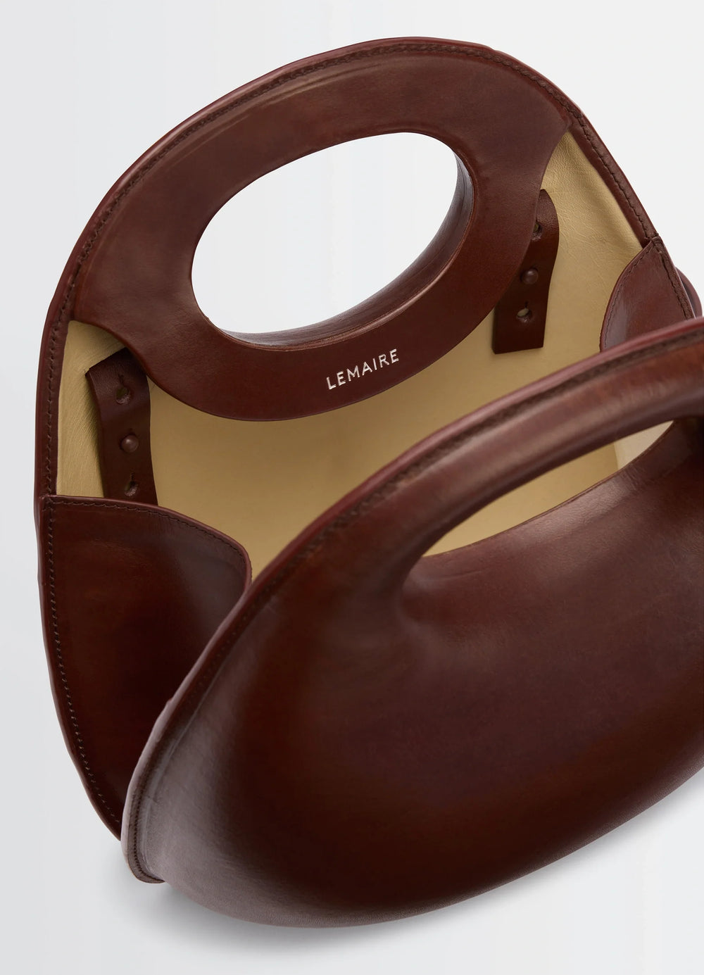 Lemaire Egg Bag in Patinated Leather Brown, product shot, top interior view integrated strap, open top
