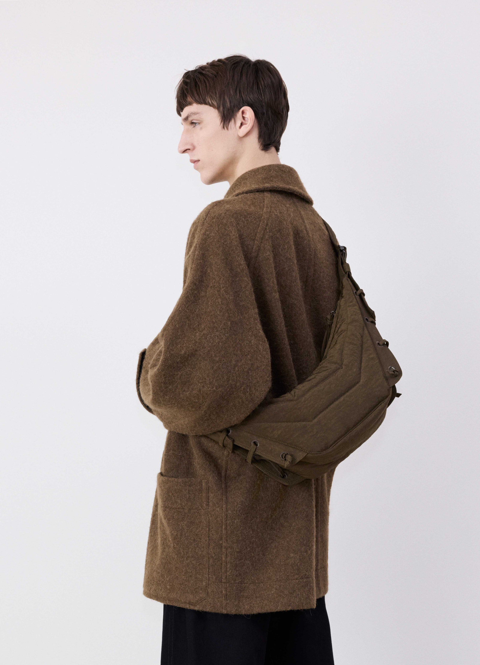 Small soft game bag in fluffy nylon canvas, model shot, side view tactile textured finish