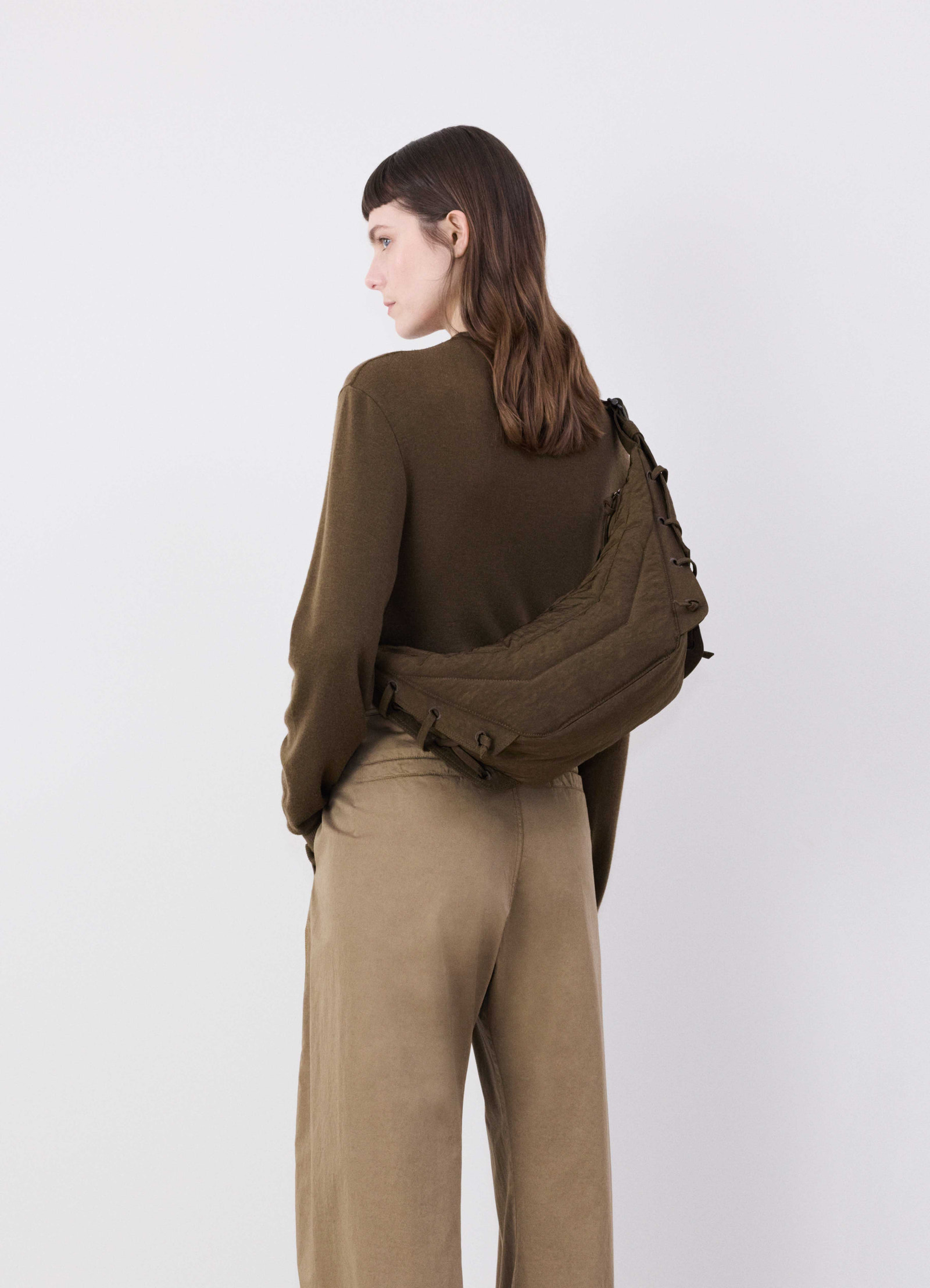 Small soft game bag in fluffy nylon canvas, model shot, rear angle view sling over shoulder