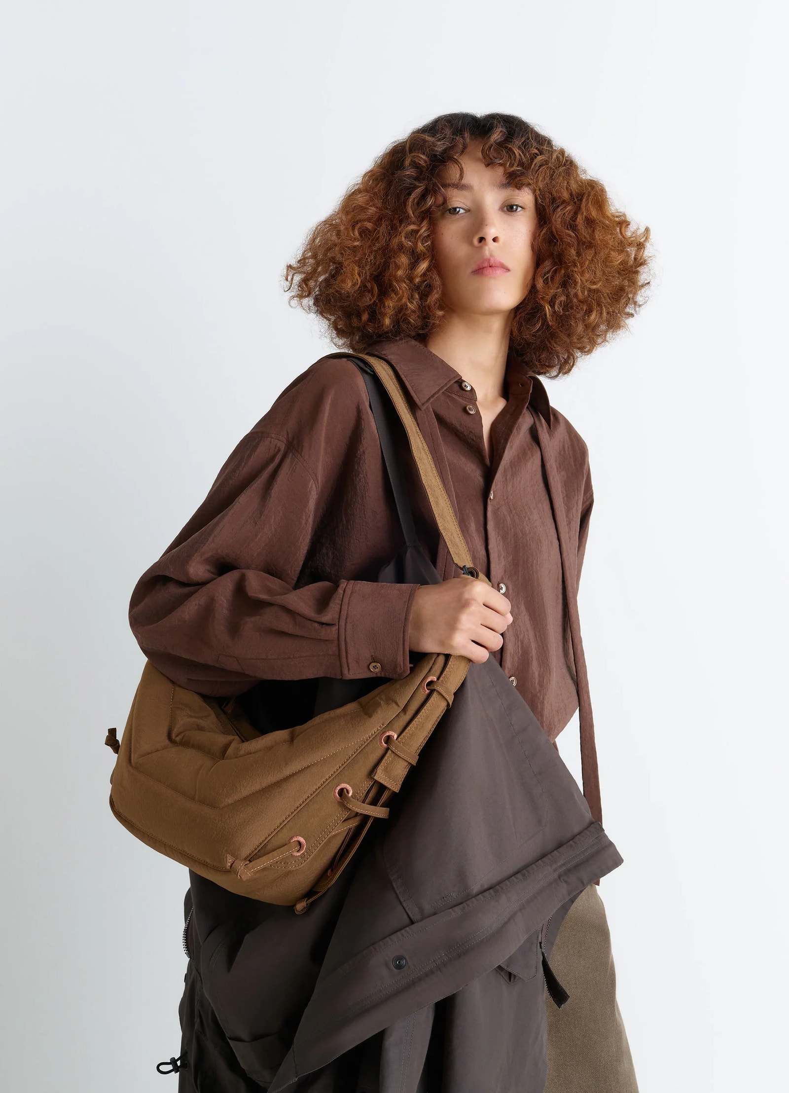 Small soft game bag in quilted water-repellent nylon, model shot, front diagonal view drawstring accent