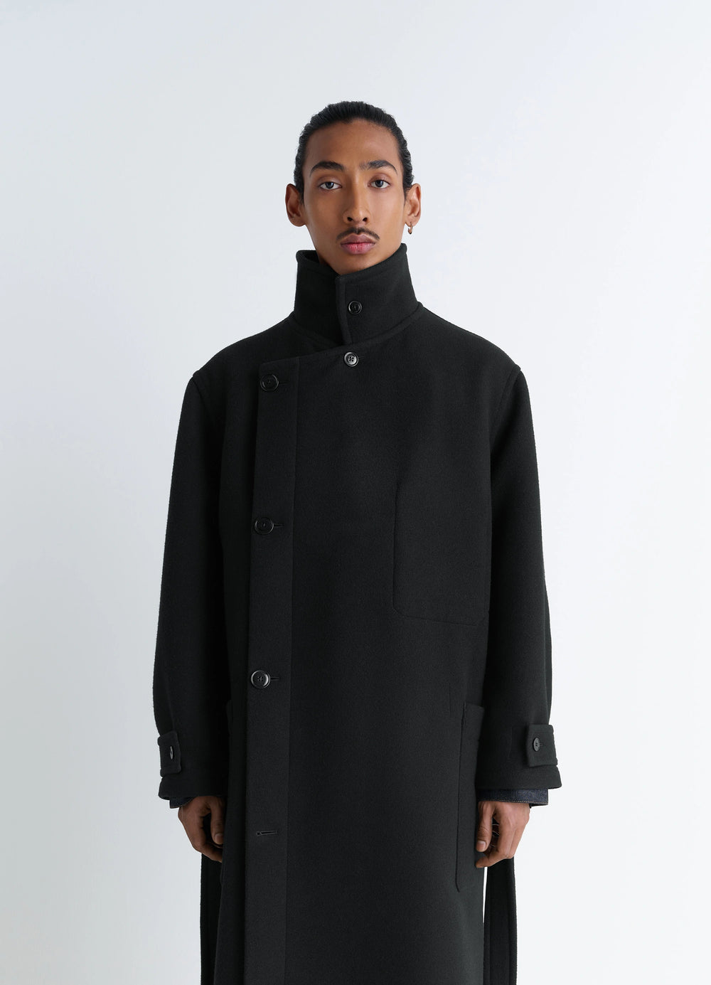 Lemaire Wrap Coat in Black Double-Faced Wool, model shot, close-up half view buttoned asymmetric closure