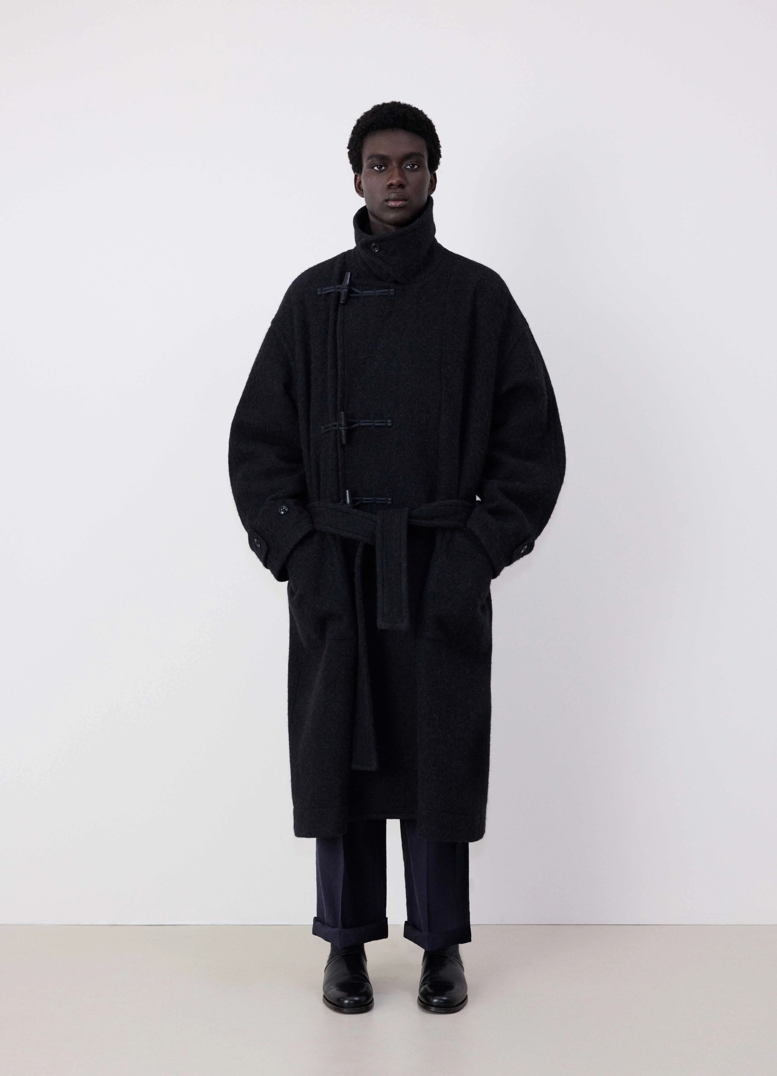 Lemaire oversized short duffle coat in dark wool and alpaca mix, model shot, front view belted oversized fit
