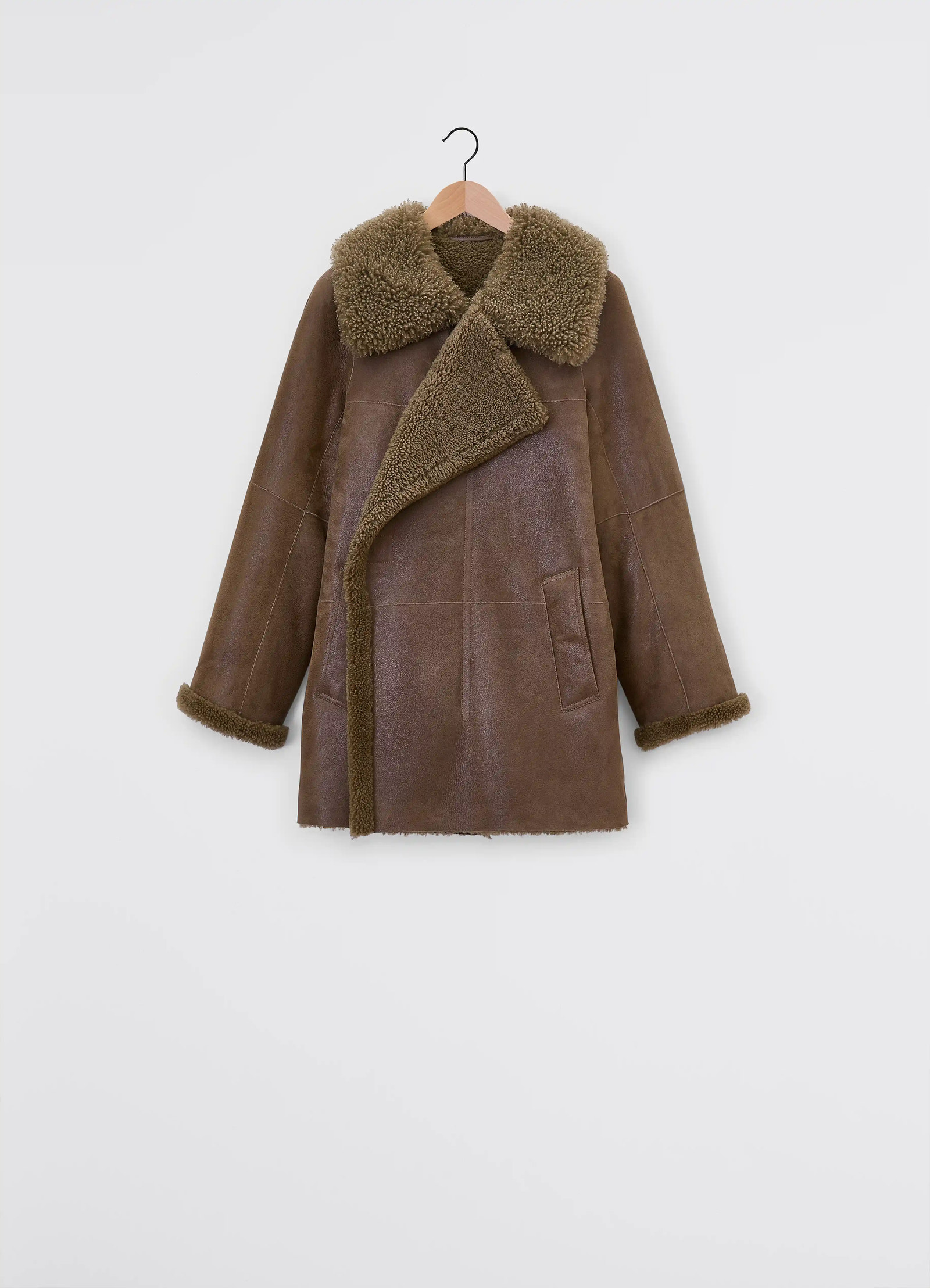 Lemaire asymmetrical shearling coat in curly lamb shearling, grained leath, product shot, detail shot trench style pockets