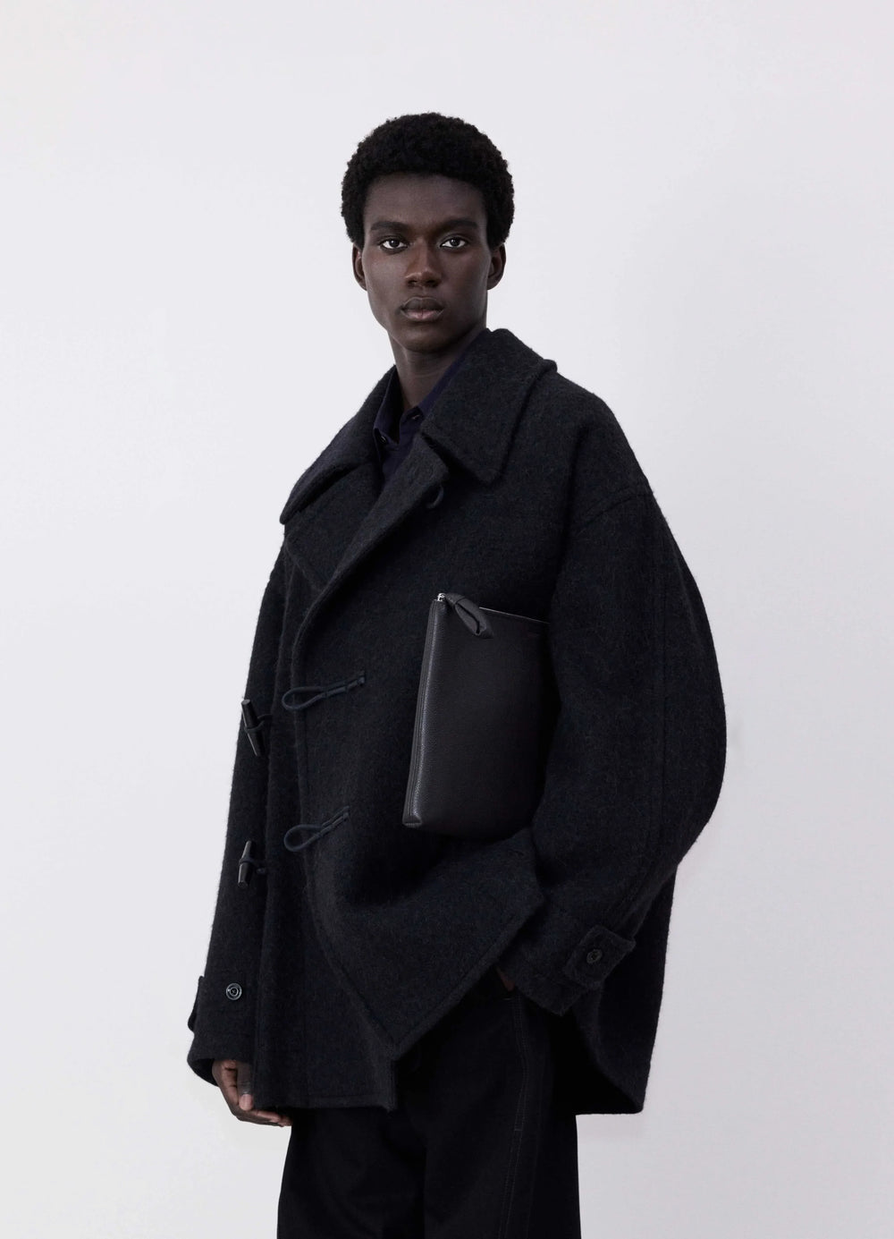 Lemaire Short Duffle Coat in dark wool and alpaca mix, model shot, front side view boxy silhouette, toggle