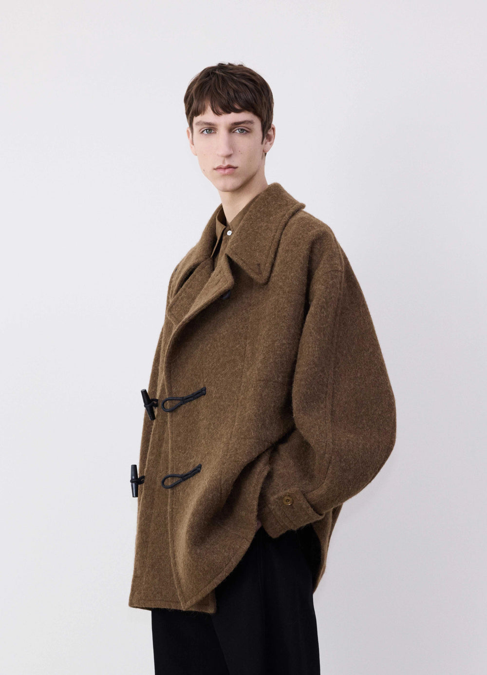Lemaire Short Duffle Coat in Brown Wool Alpaca Mix, model shot, three-quarter view half raglan sleeves