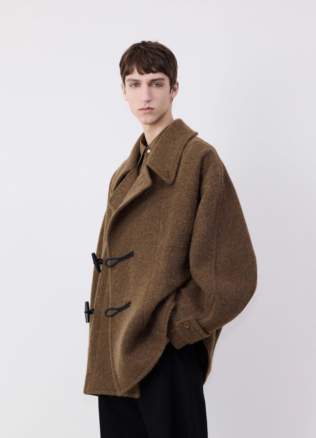 Lemaire Short Duffle Coat in Brown Wool Alpaca Mix, model shot, three-quarter view half raglan sleeves