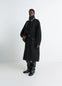 Lemaire Duffle Coat in Double-faced wool black, model shot, front three-quarter view shiny piping and belted