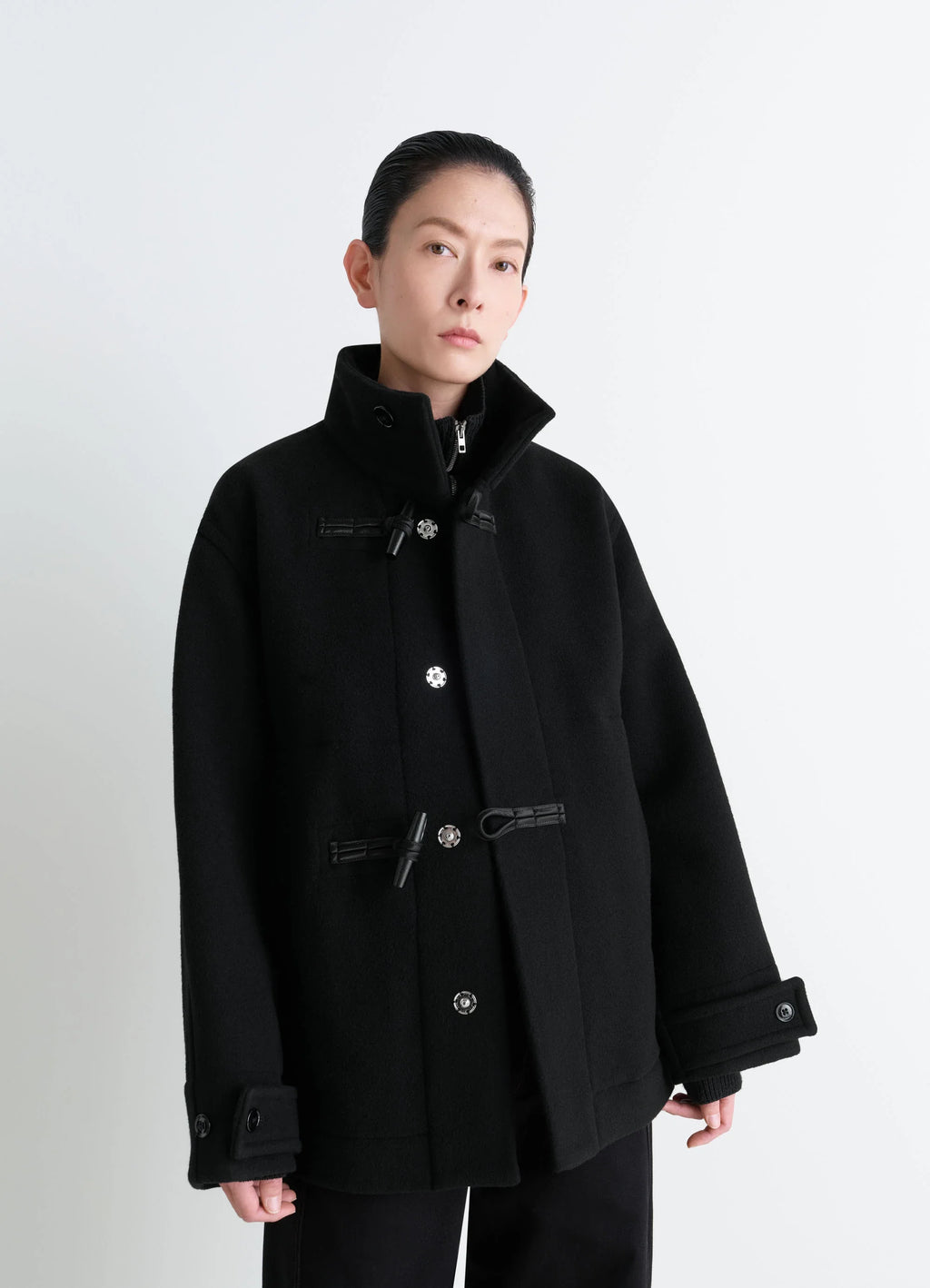 Lemaire Short Duffle Coat in Black Double-Faced Wool, model shot, Front view Wide cut with shiny piping