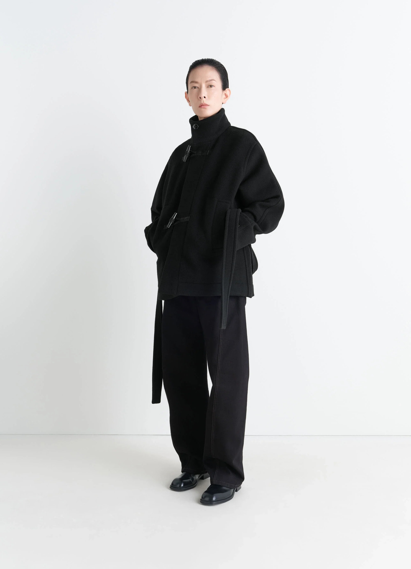 Lemaire short duffle coat in black double-faced wool, model shot, front view belted waist