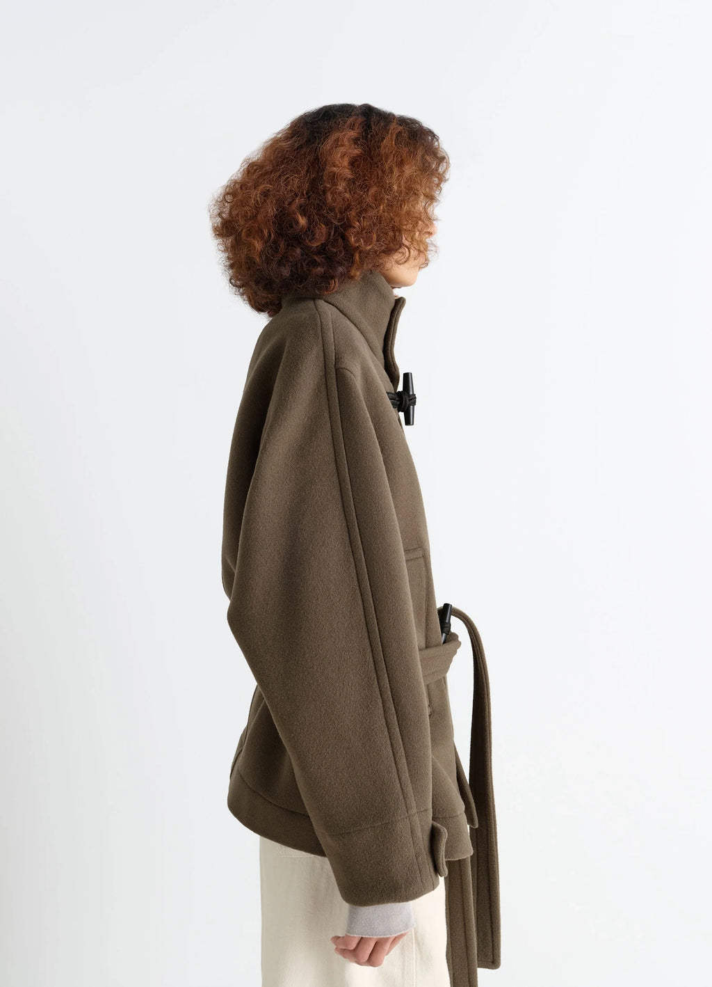 Lemaire Short Duffle Coat in Olive Double-Faced Wool, model shot, profile view high collar silhouette