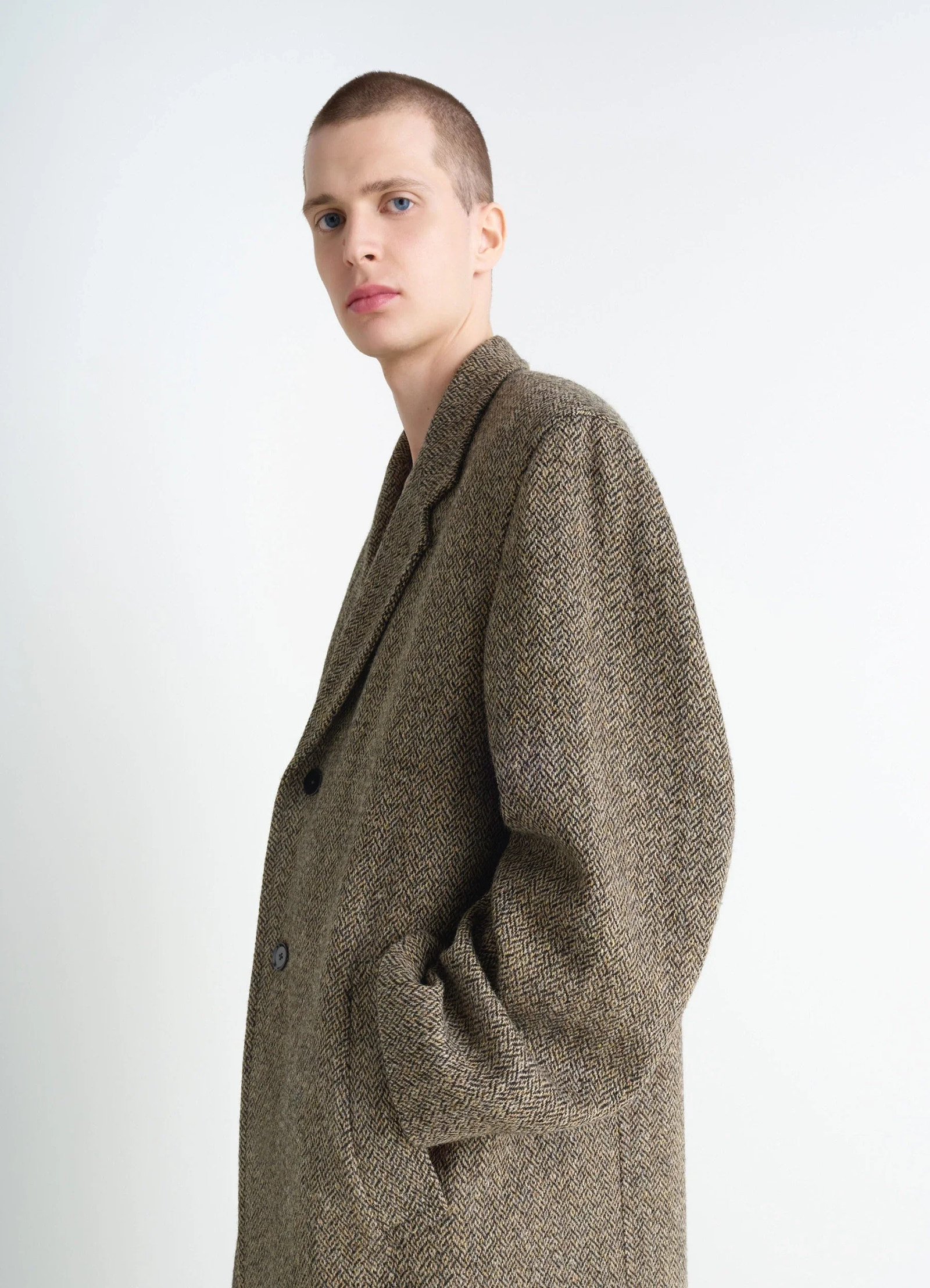 Chesterfield coat in herringbone harris tweed, model shot, side profile view structured lapel design