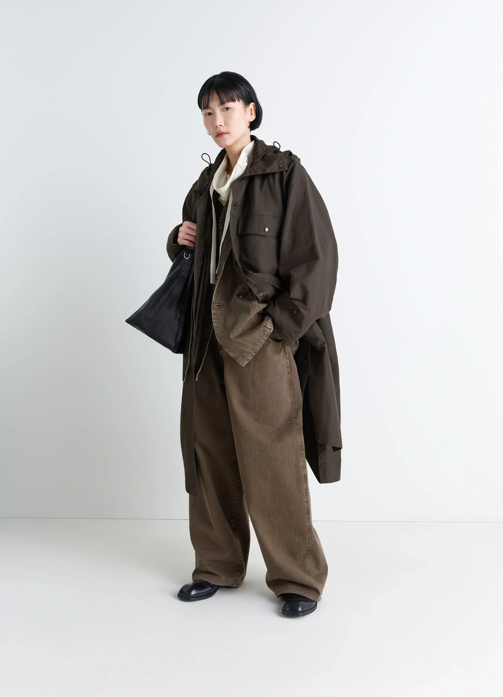 Lemaire Utility Raincoat in Khaki Linen Cotton Blend, model shot, three-quarter view oversized sleeves