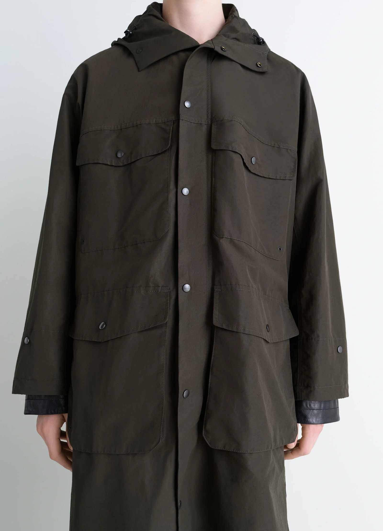 Lemaire utility raincoat in khaki linen cotton blend, model shot, front torso detail shot buttoned pocket details