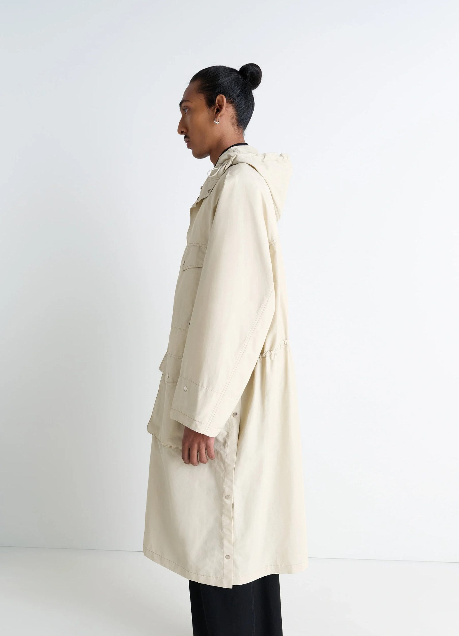 Lemaire utility raincoat in beige linen cotton blend, model shot, side view waist drawstring detail