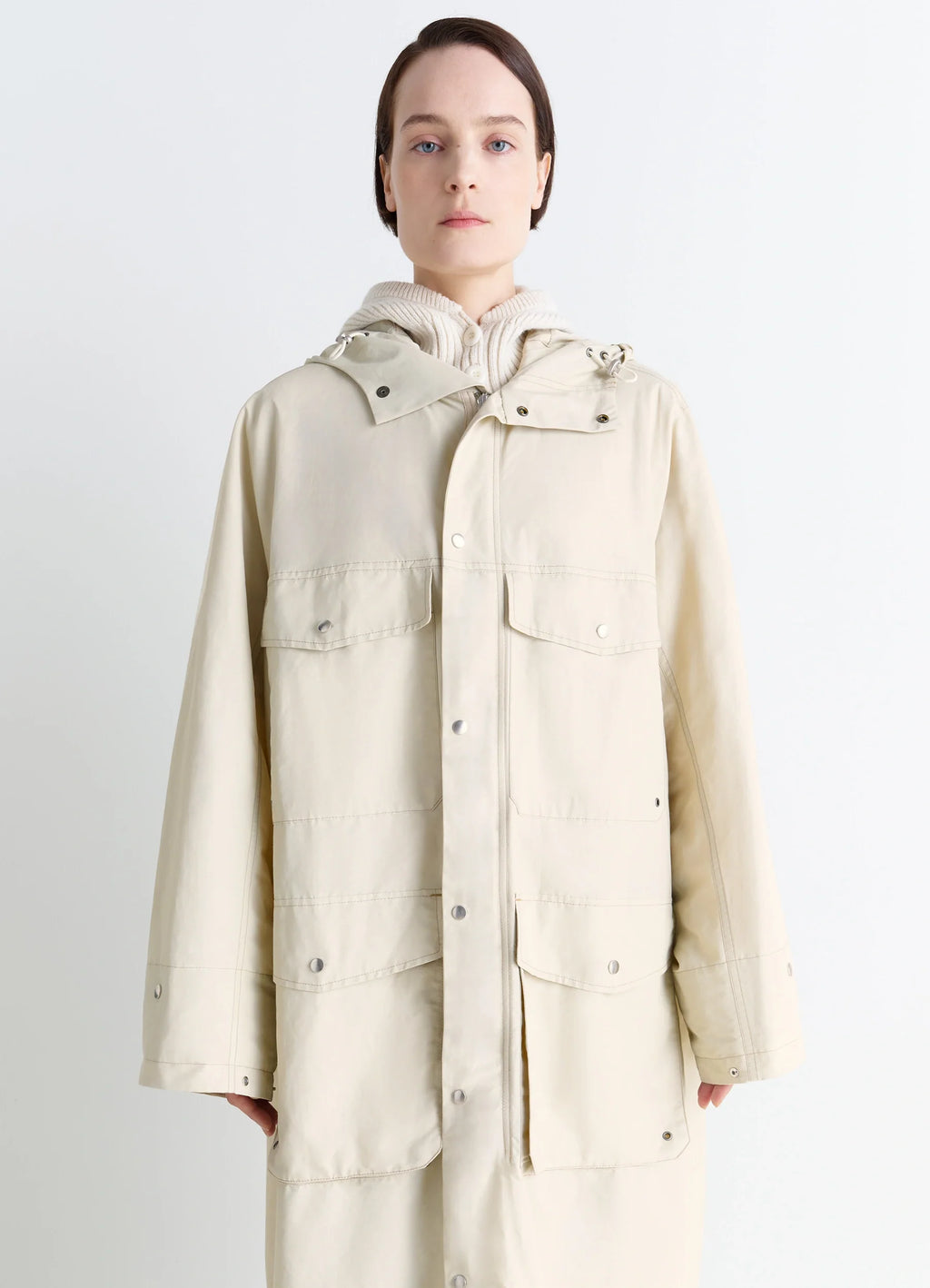 Lemaire Utility Raincoat in Beige Linen Cotton Blend, model shot, close-up front view buttoned chest pockets