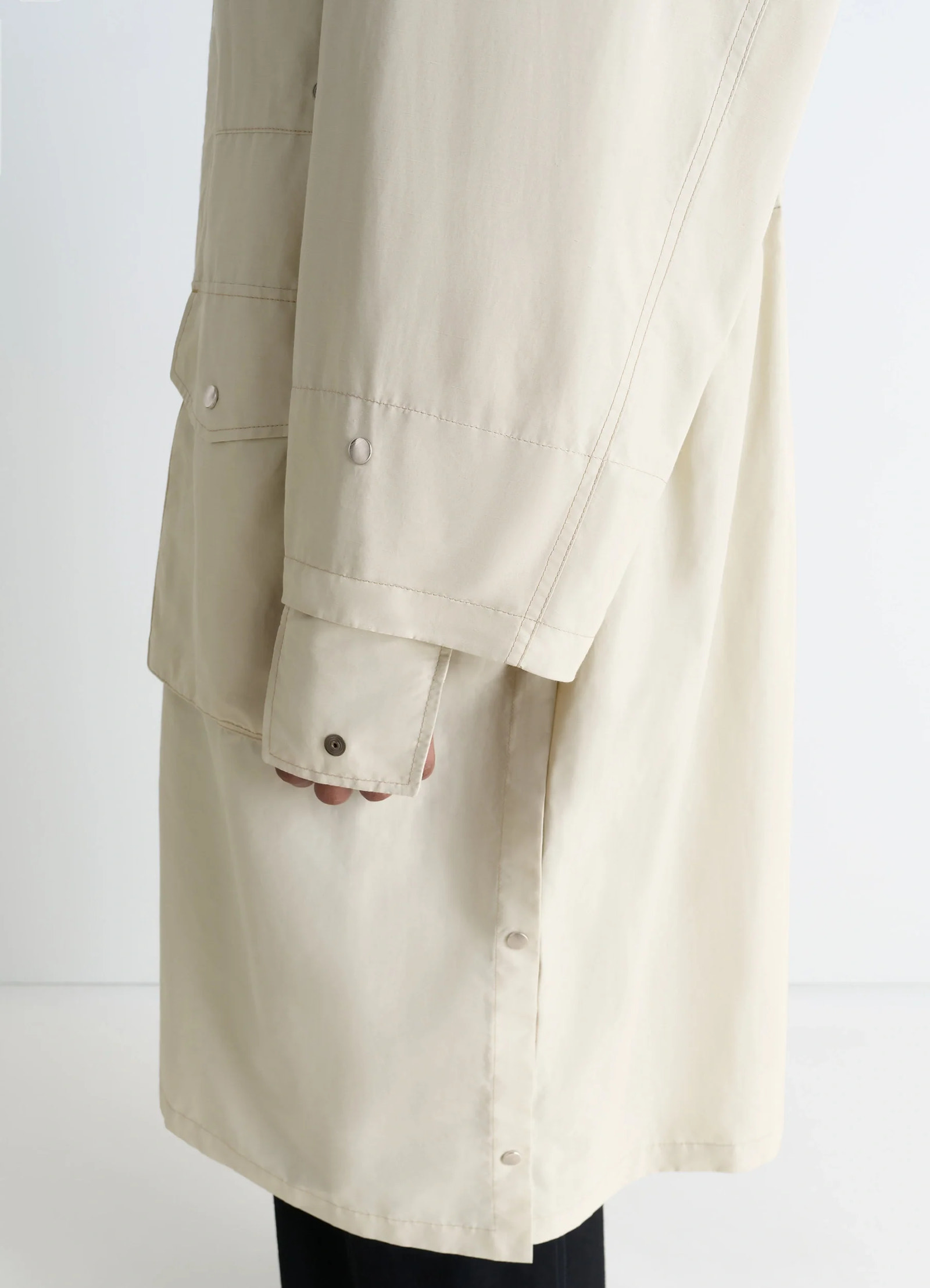 Lemaire utility raincoat in beige linen cotton blend, product shot, sleeve close-up buttoned sleeve cuff